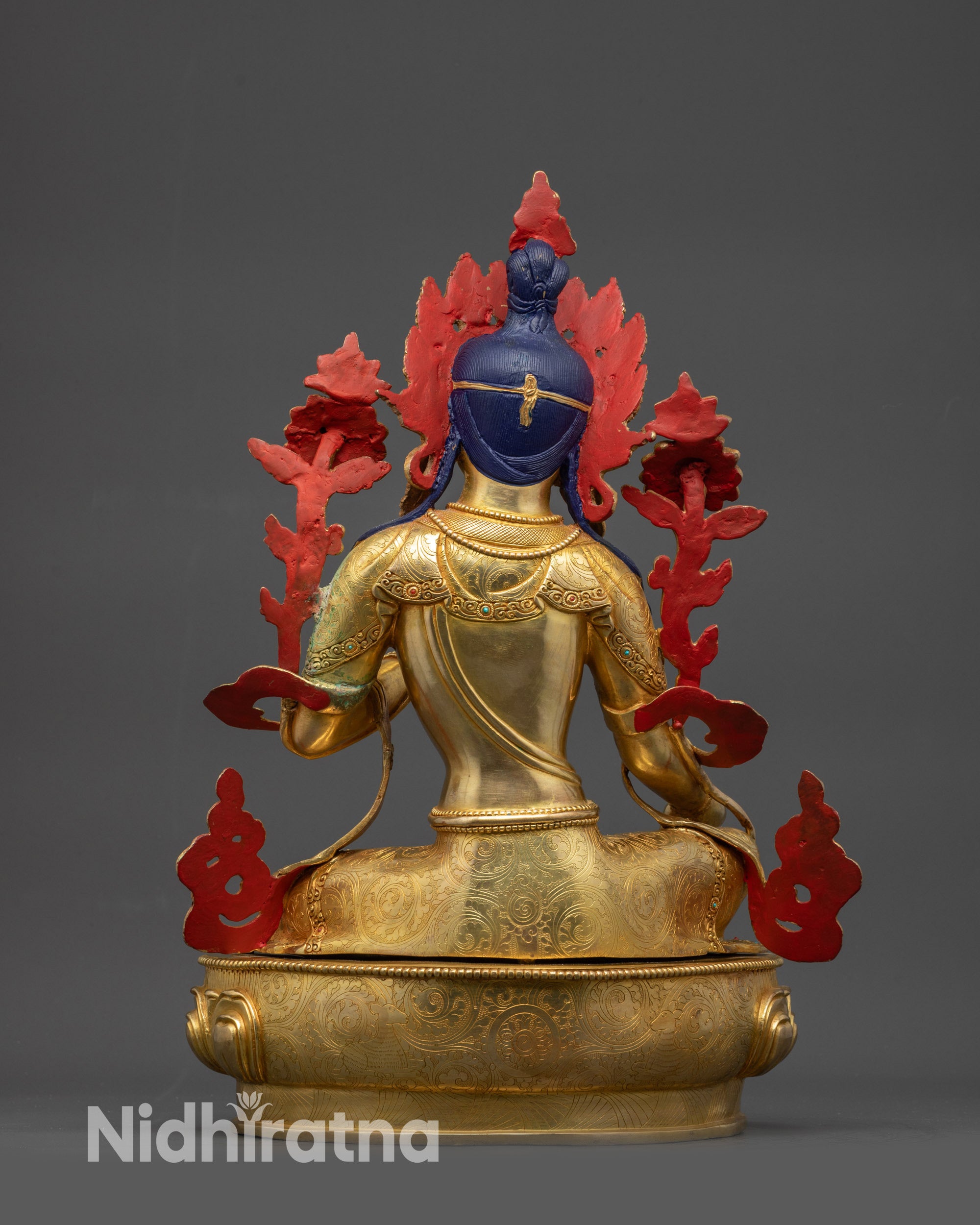 Back view Green Tara statue showing carved robe patterns and lotus seat jewelry