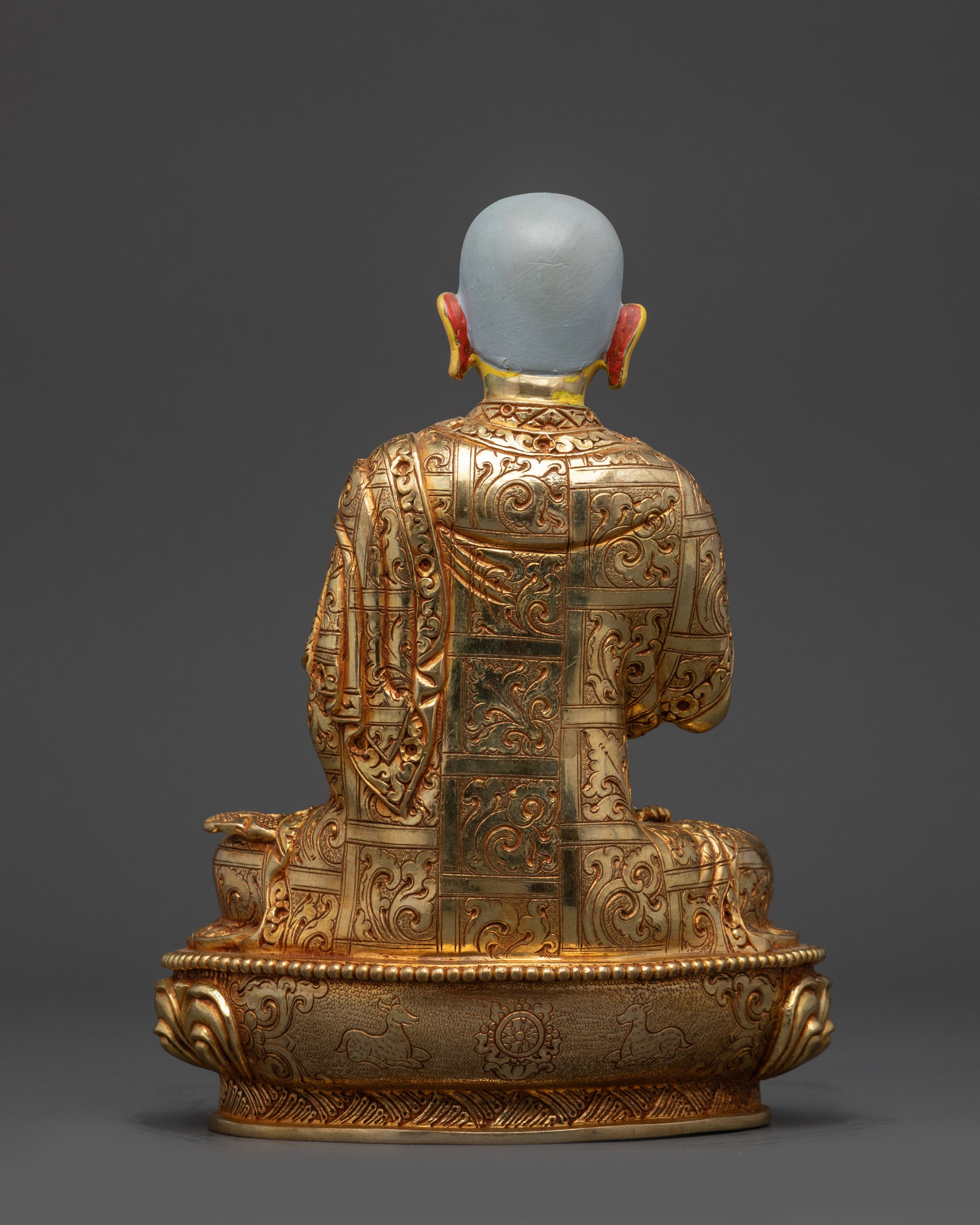 Back view Gyaltsab Je statue showing detailed robe engravings and lotus base