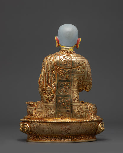 Back view Gyaltsab Je statue showing detailed robe engravings and lotus base