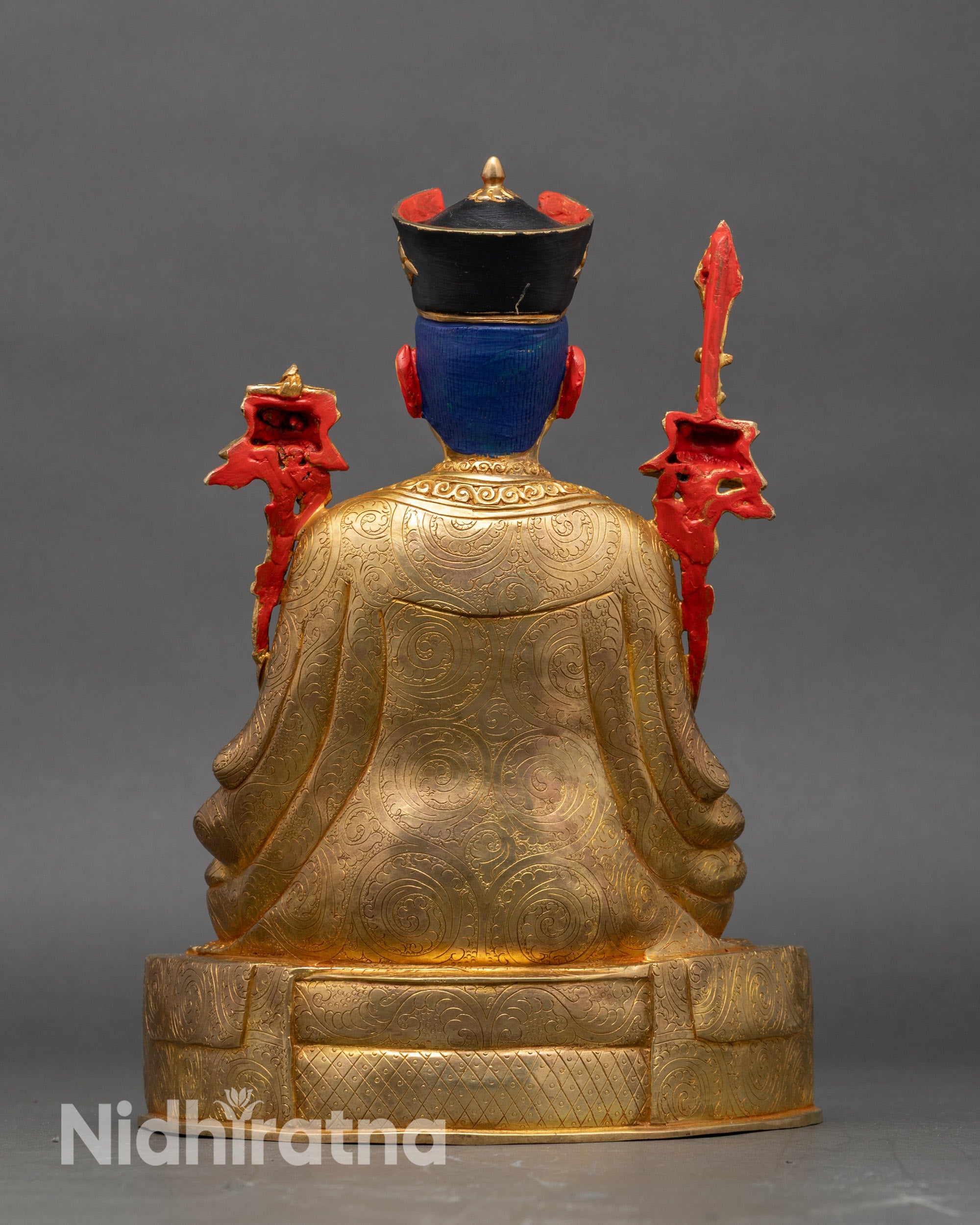 Back view Himalayan 16th Karmapa statue seated on ornate pedestal with flowing robes