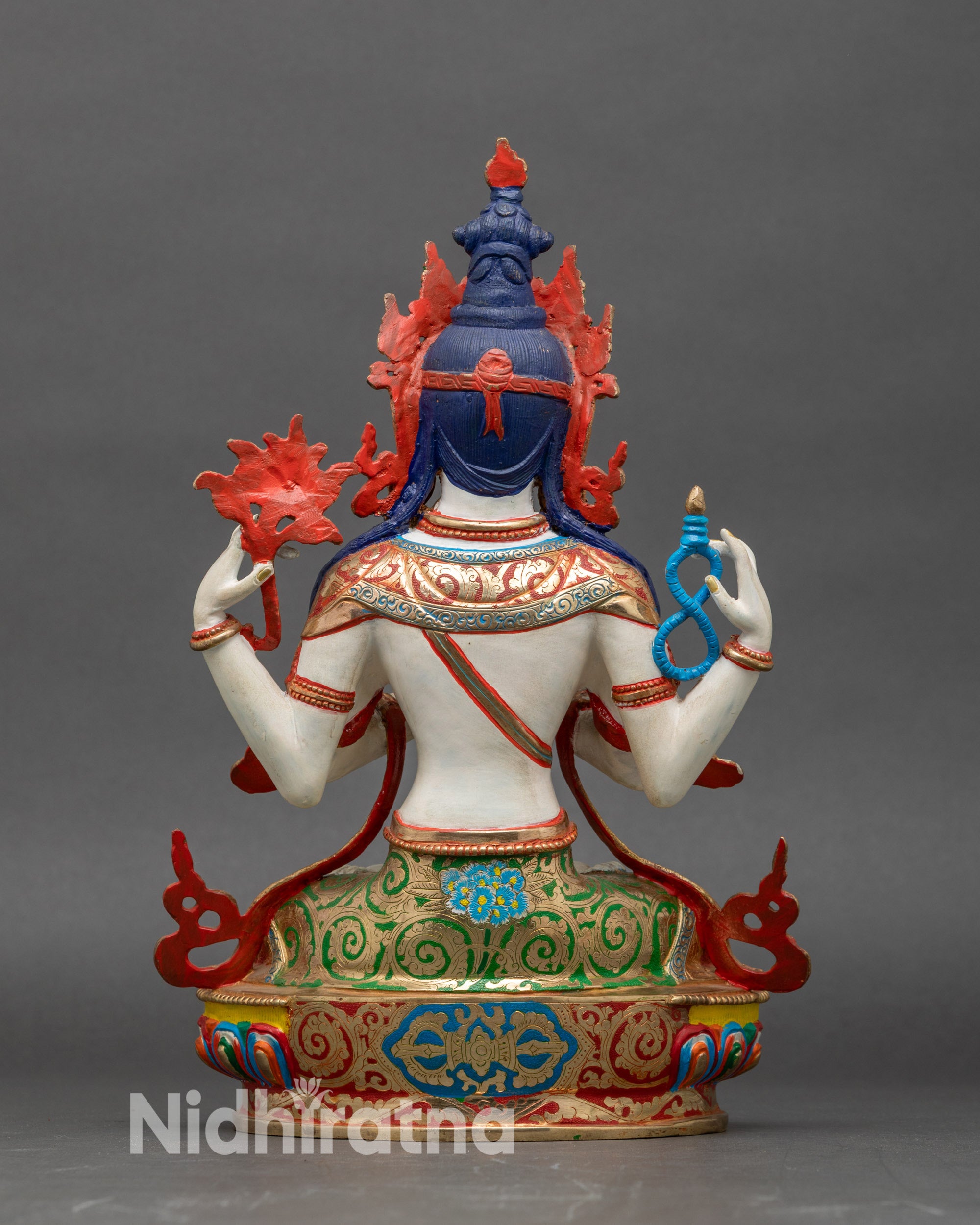 Back view Himalayan Chenrezig statue seated on decorative lotus base with vibrant colors
