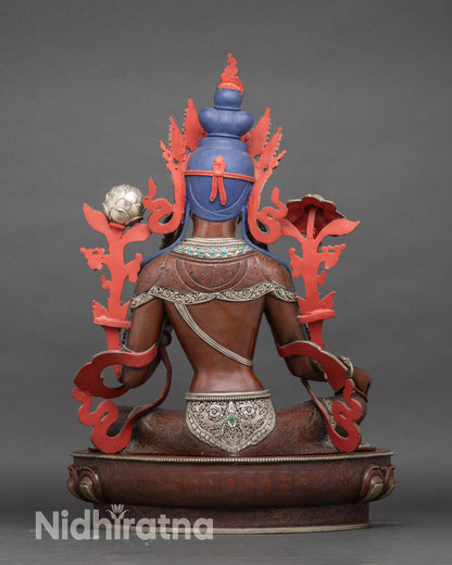 Back view Himalayan Green Tara statue with intricately carved robes and silver details