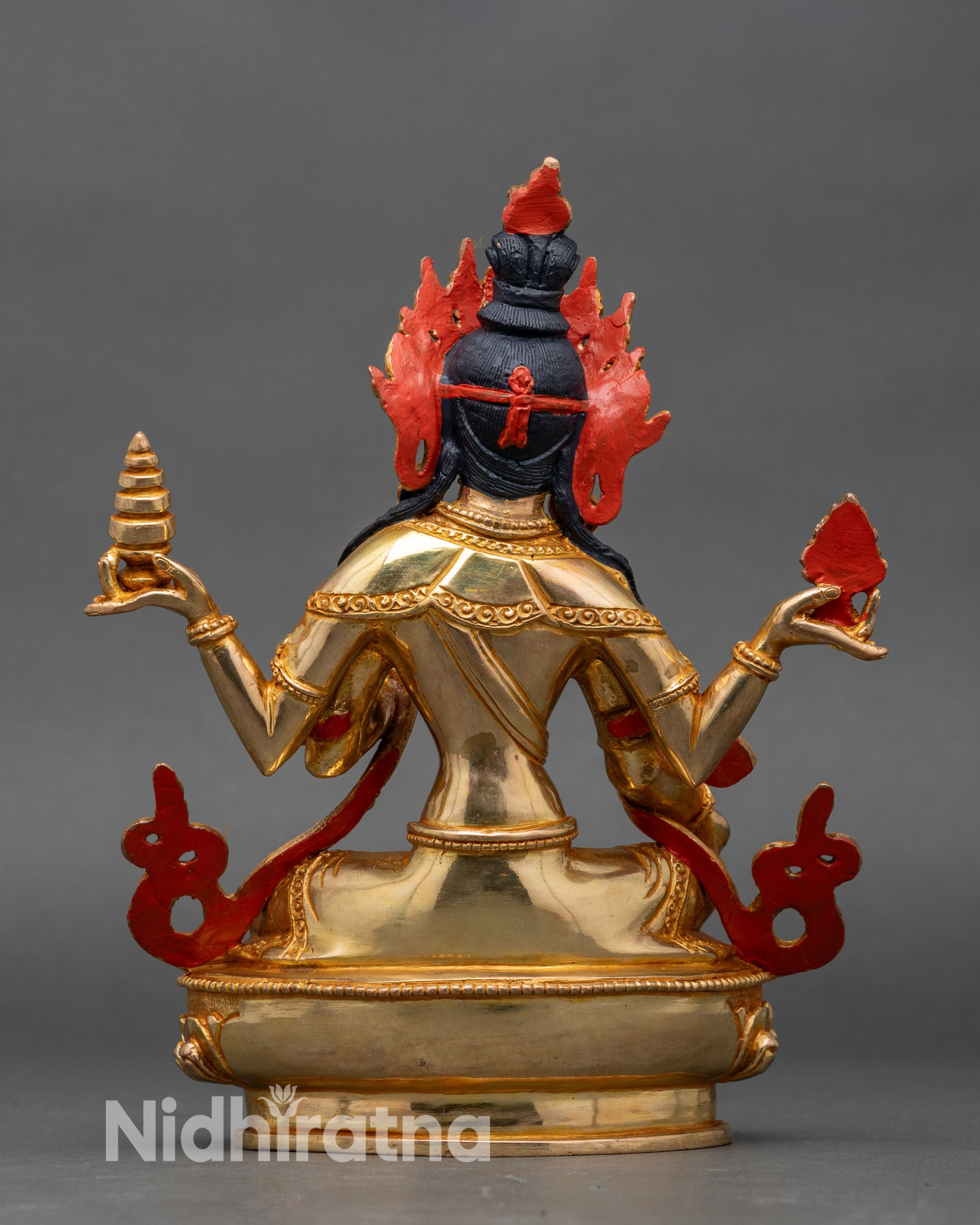 Back view Himalayan Lakshmi statue seated on lotus pedestal with hand-painted details