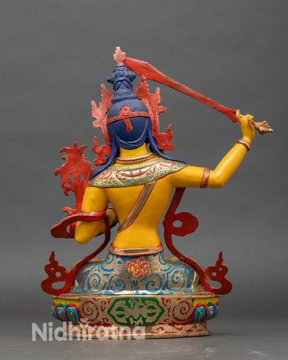 Back view Himalayan Manjushree statue seated on lotus pedestal with floral robes