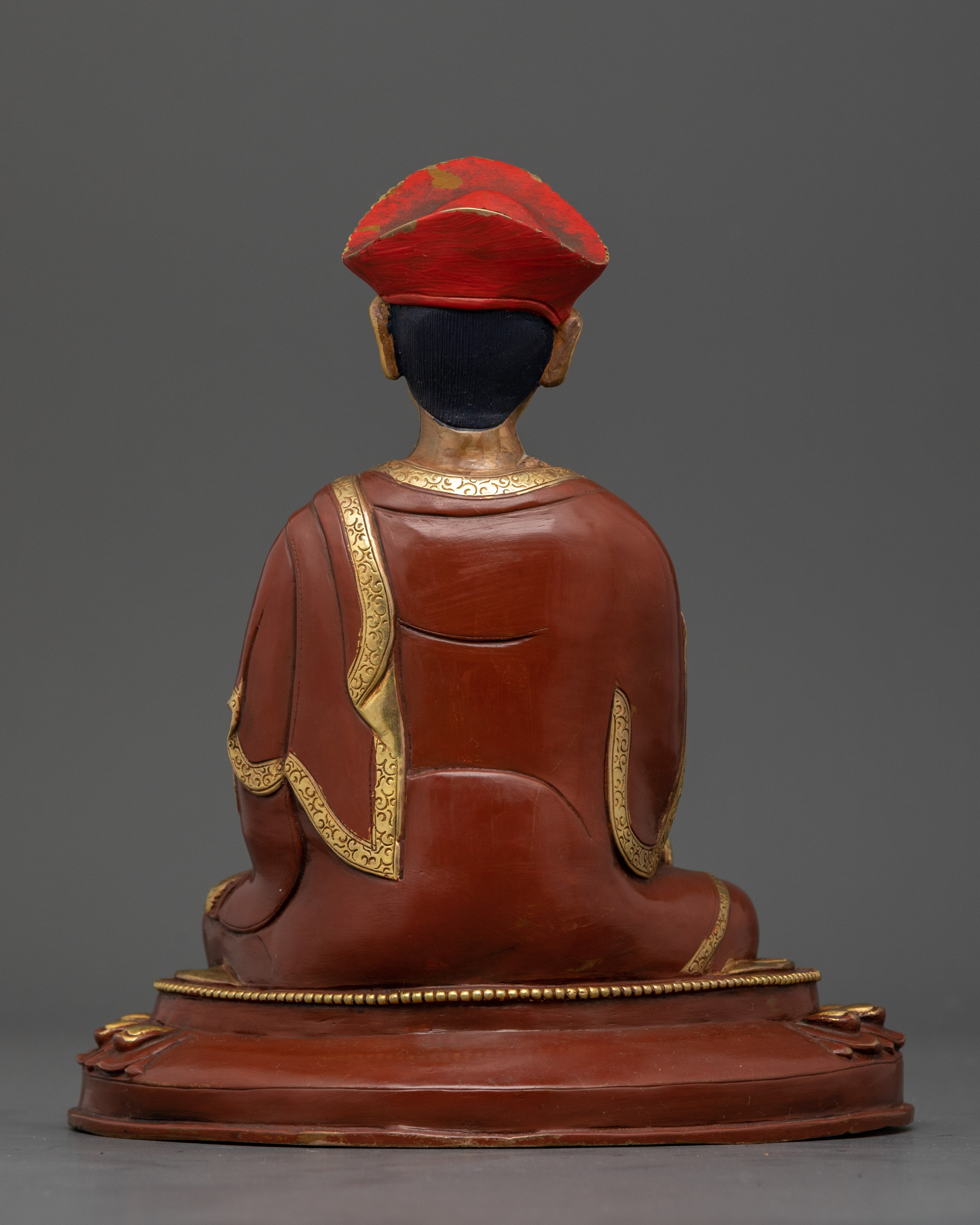 Back view Karmapa gold-accented copper statue, intricate crown, and lotus throne details