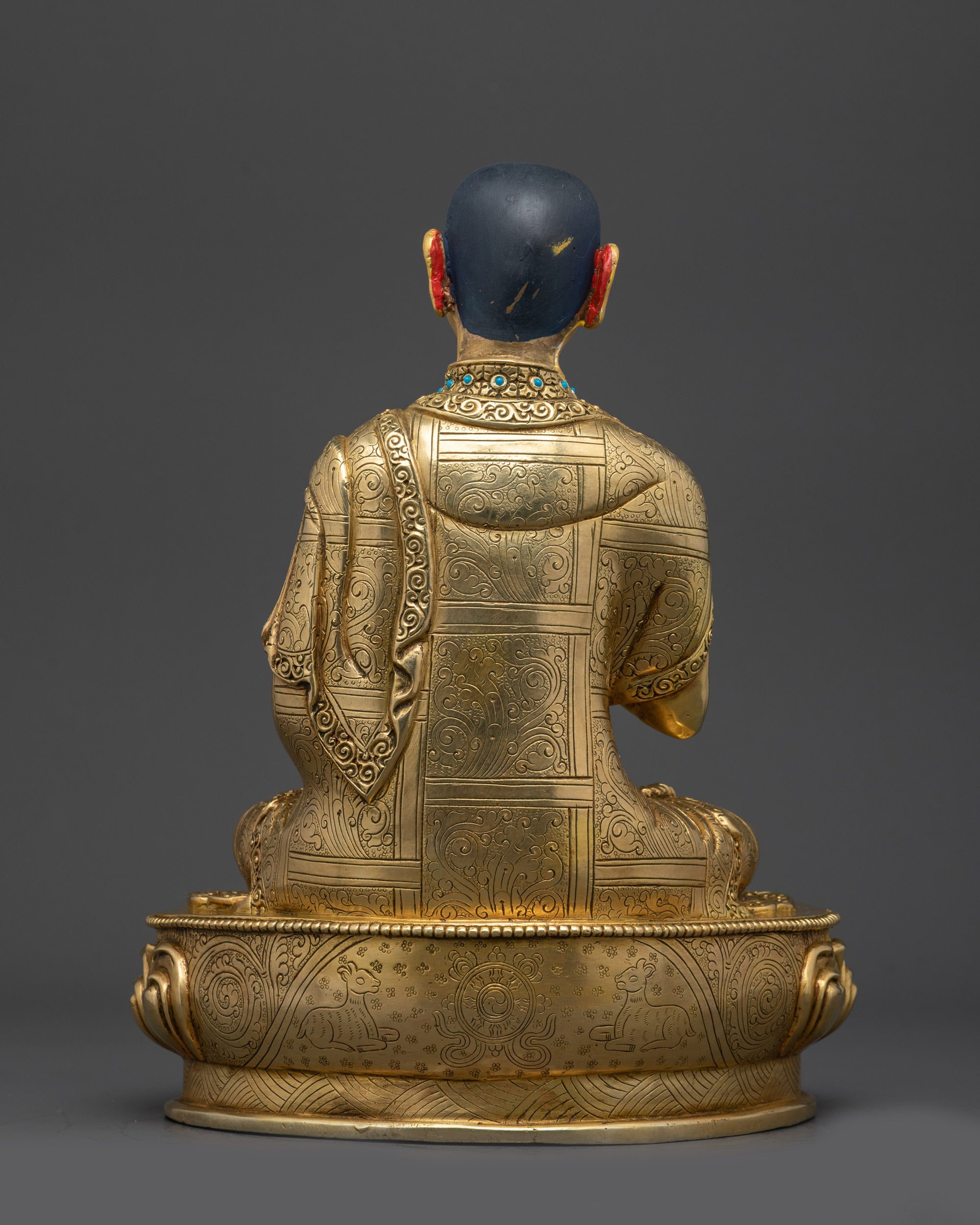 Back view Khedrup Je statue highlighting detailed carvings and sacred base