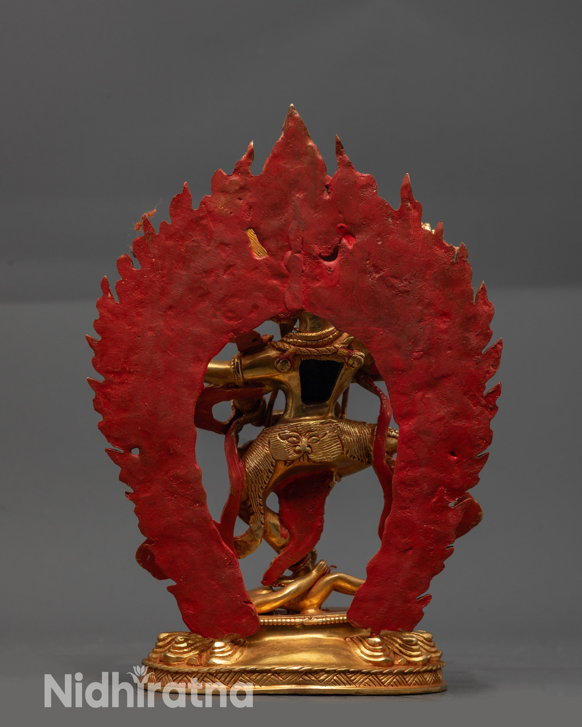 Back view Kurukulla Buddhist goddess sculpture highlighting gold-fire gilding and halo