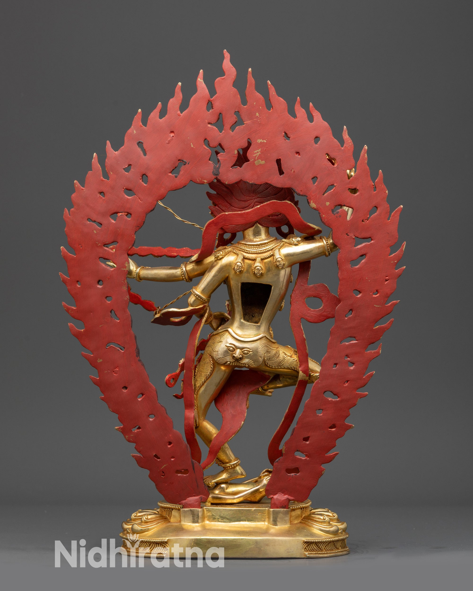 Back view Kurukulla statue highlighting gold fire-gilded body and sacred tantric implements