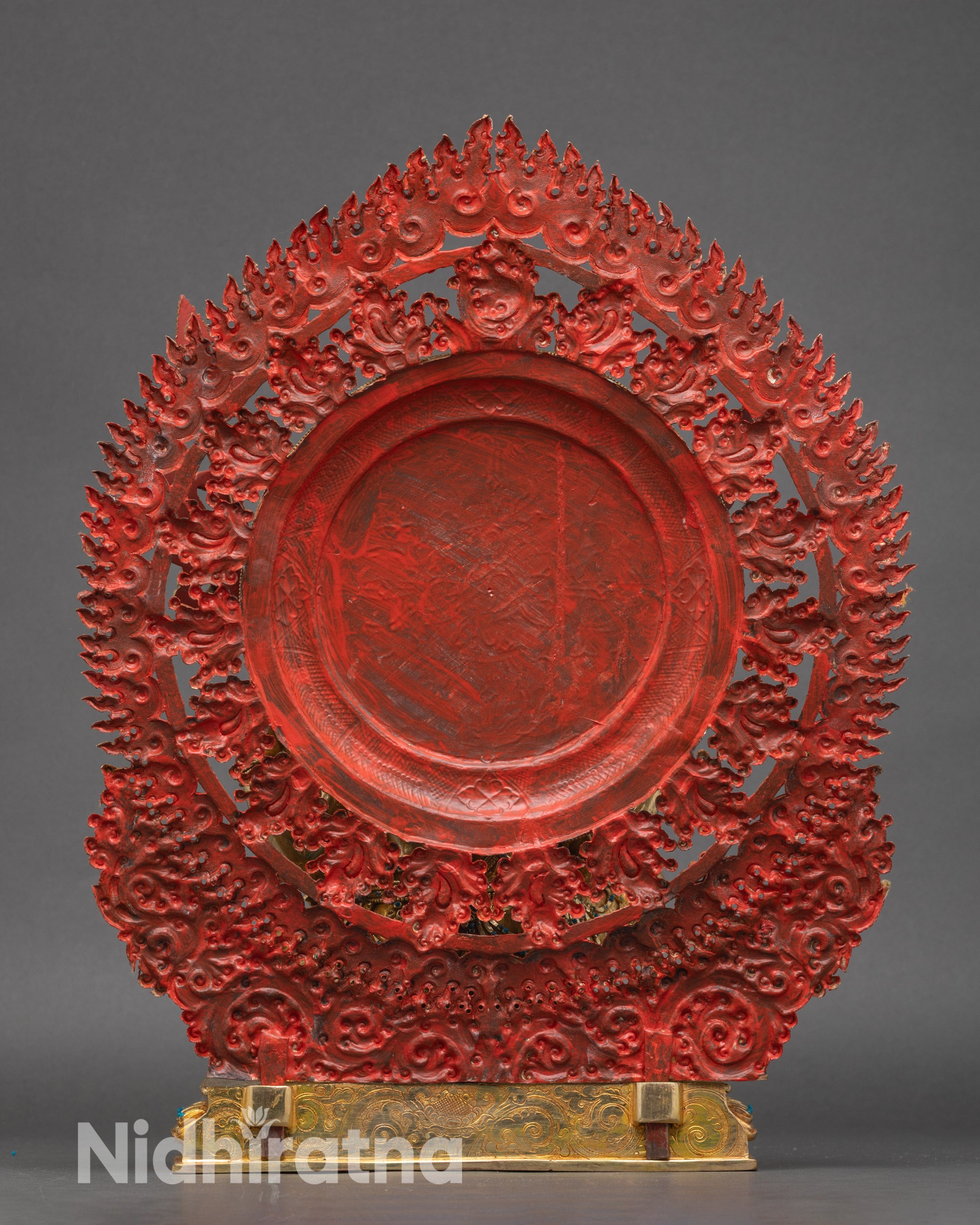 Back view Mahakala statue with ornate flame halo and detailed robe patterns.
