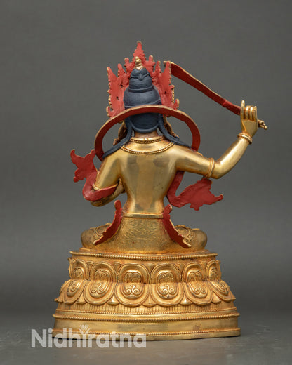 Back view Manjushree Buddhist statue, a gold sculpture for meditation and study altar