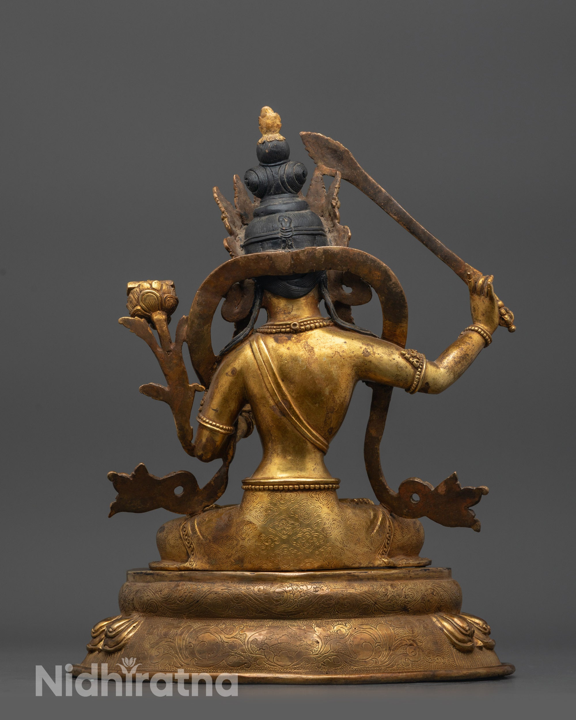 Back view Manjushri Bodhisattva holding utpala flower and double-edged sword with wisdom flame