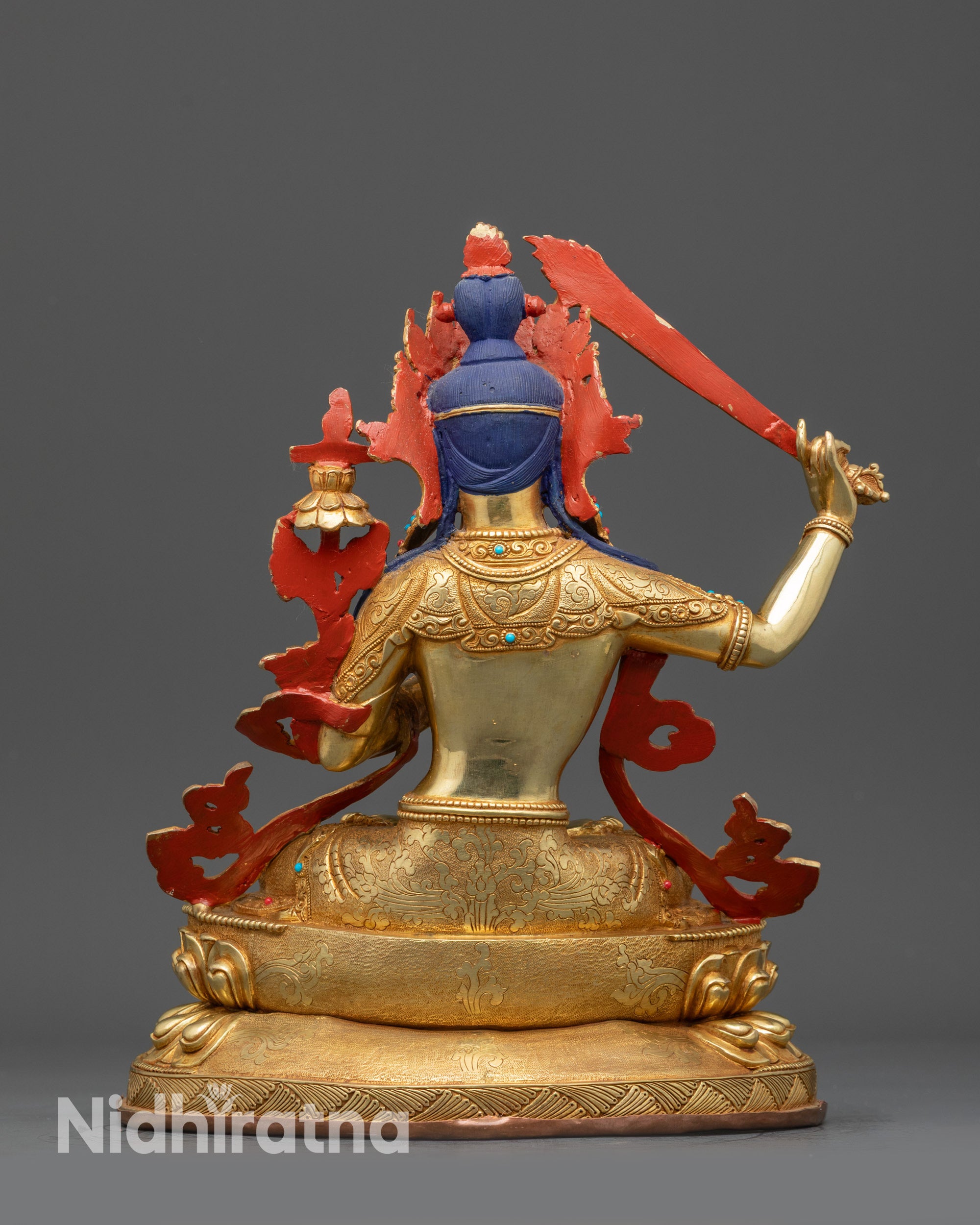 Back view Manjushri statue with intricately carved robes and lotus base