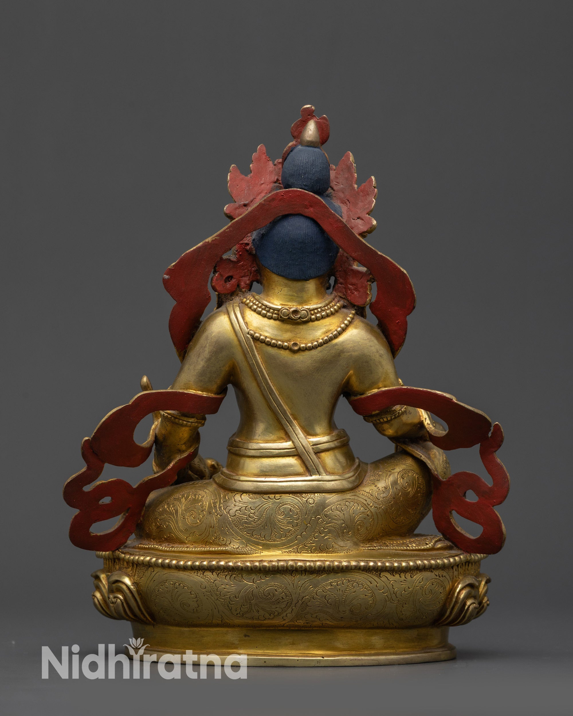 Back view Nepalese Dzambhala Statue showing swirling patterned robes and engraved armlets