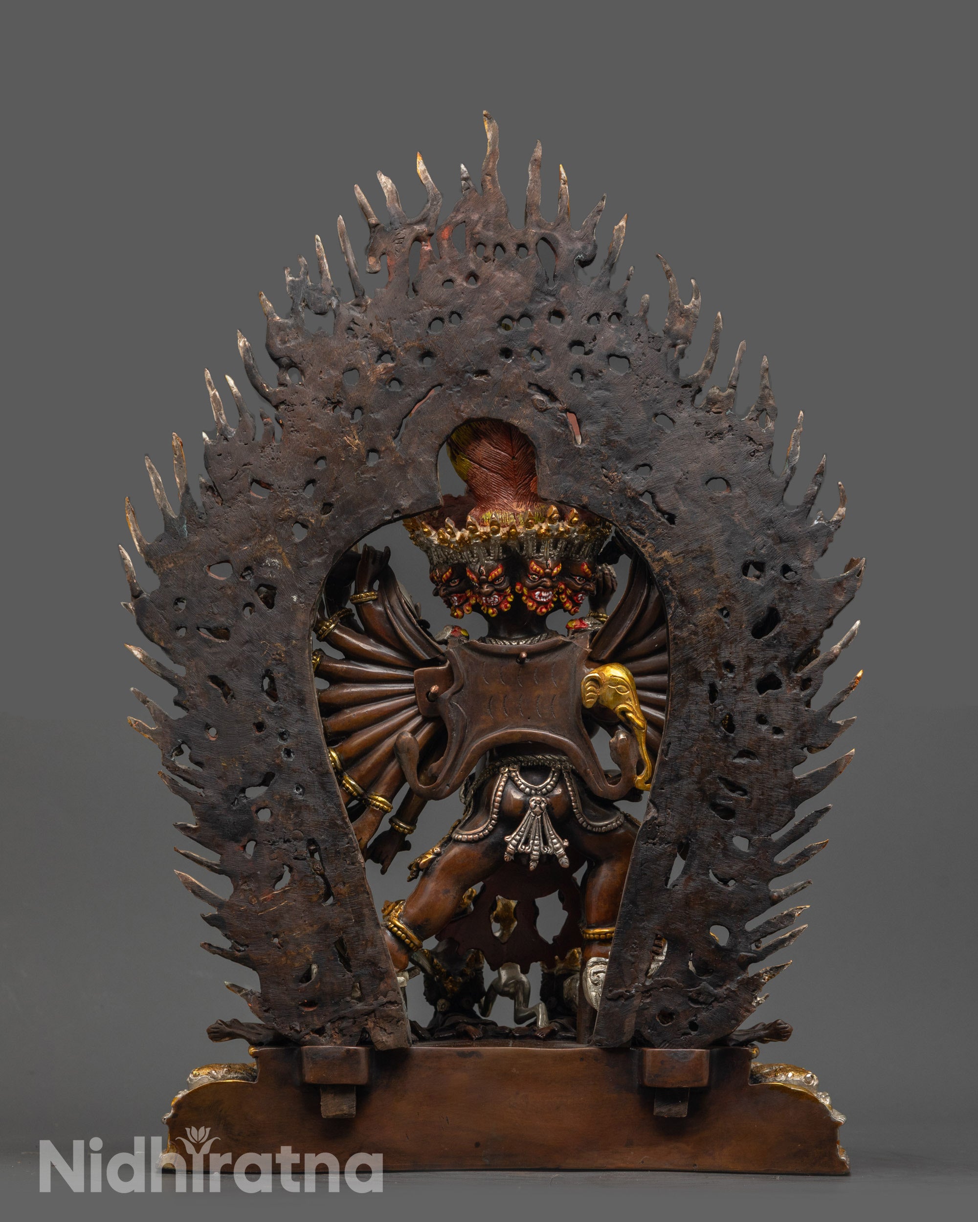Back view Oxidized Yamantaka on lotus seat with miniature figure at the foot