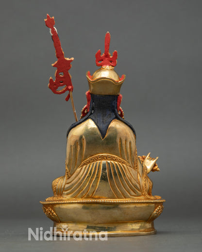 Back view Padmasambhava copper statue intricate swirling garments Nepalese sacred art