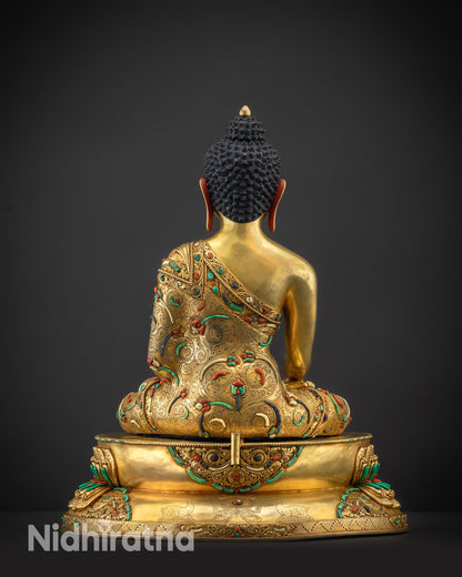Back view Shakyamuni Buddha statue without halo highlighting robe texture and carvings
