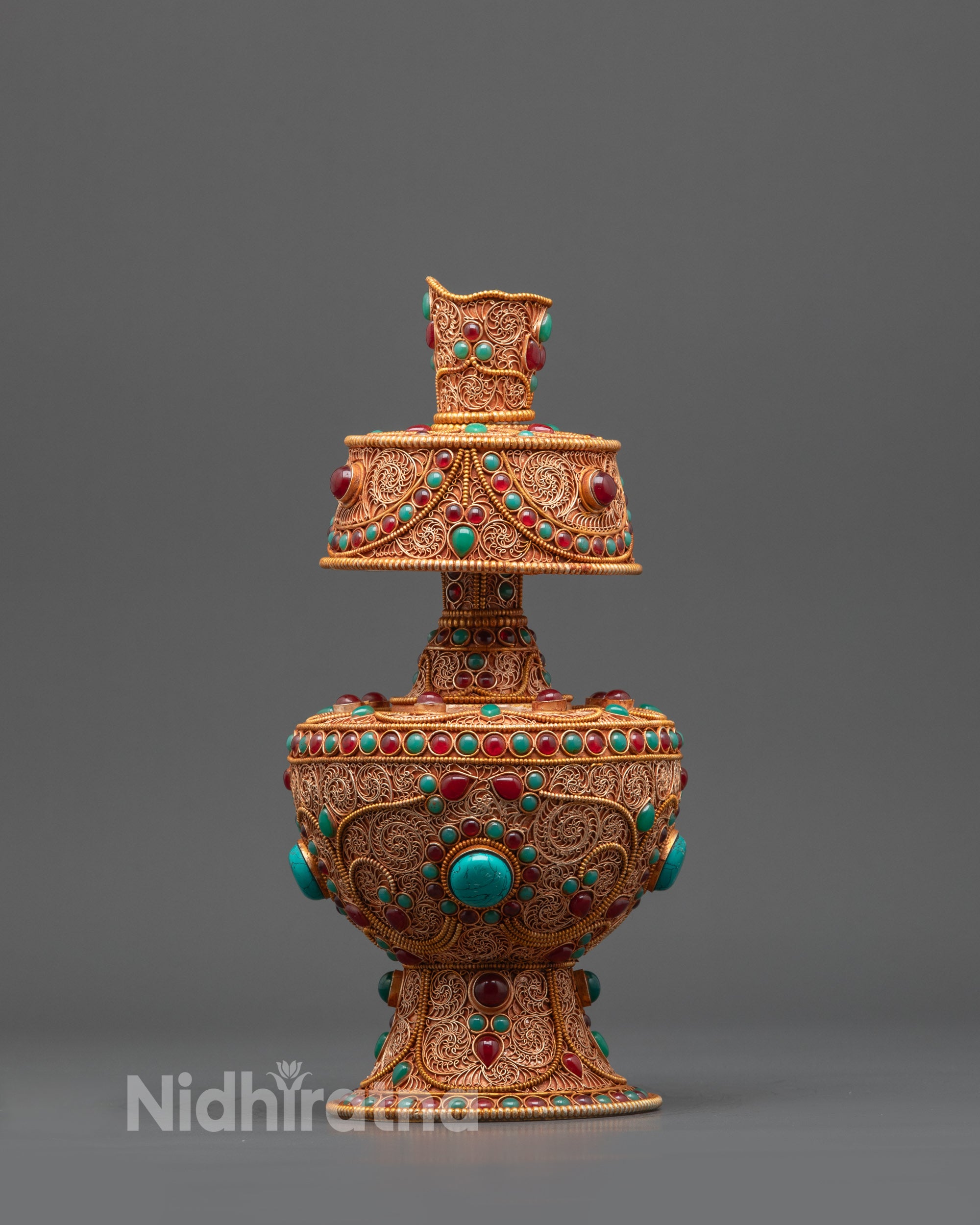 Back view Tibetan Bhumba showing rounded body with detailed filigree and stone accents