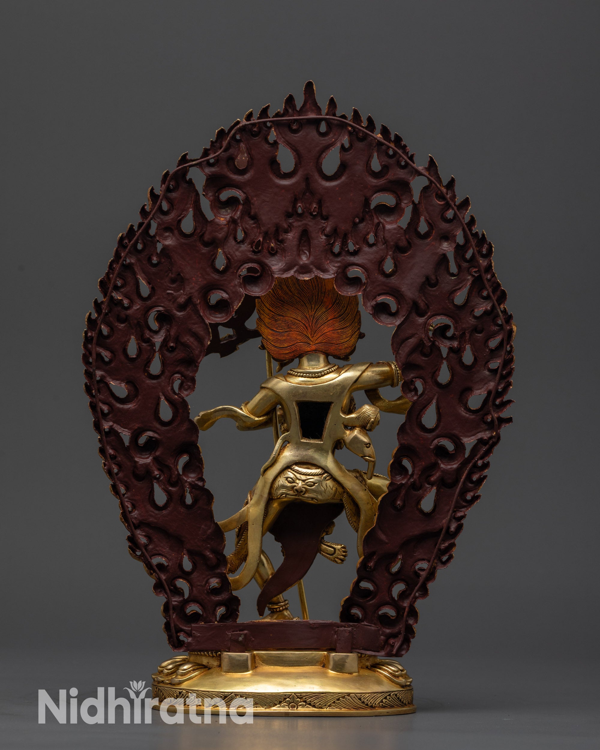 Back view Troma Nagmo statue with blazing halo, polished finish, and skull garland