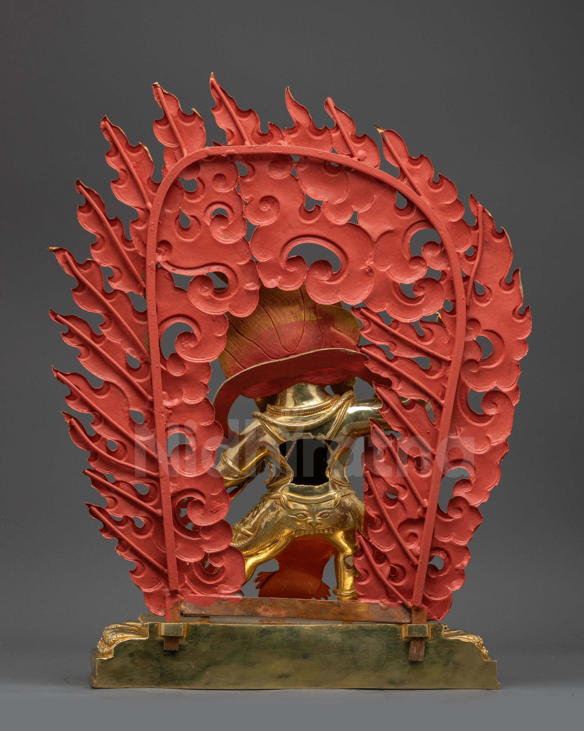 Back view Vajrapani statue highlighting intricate patterned garments and gilded details