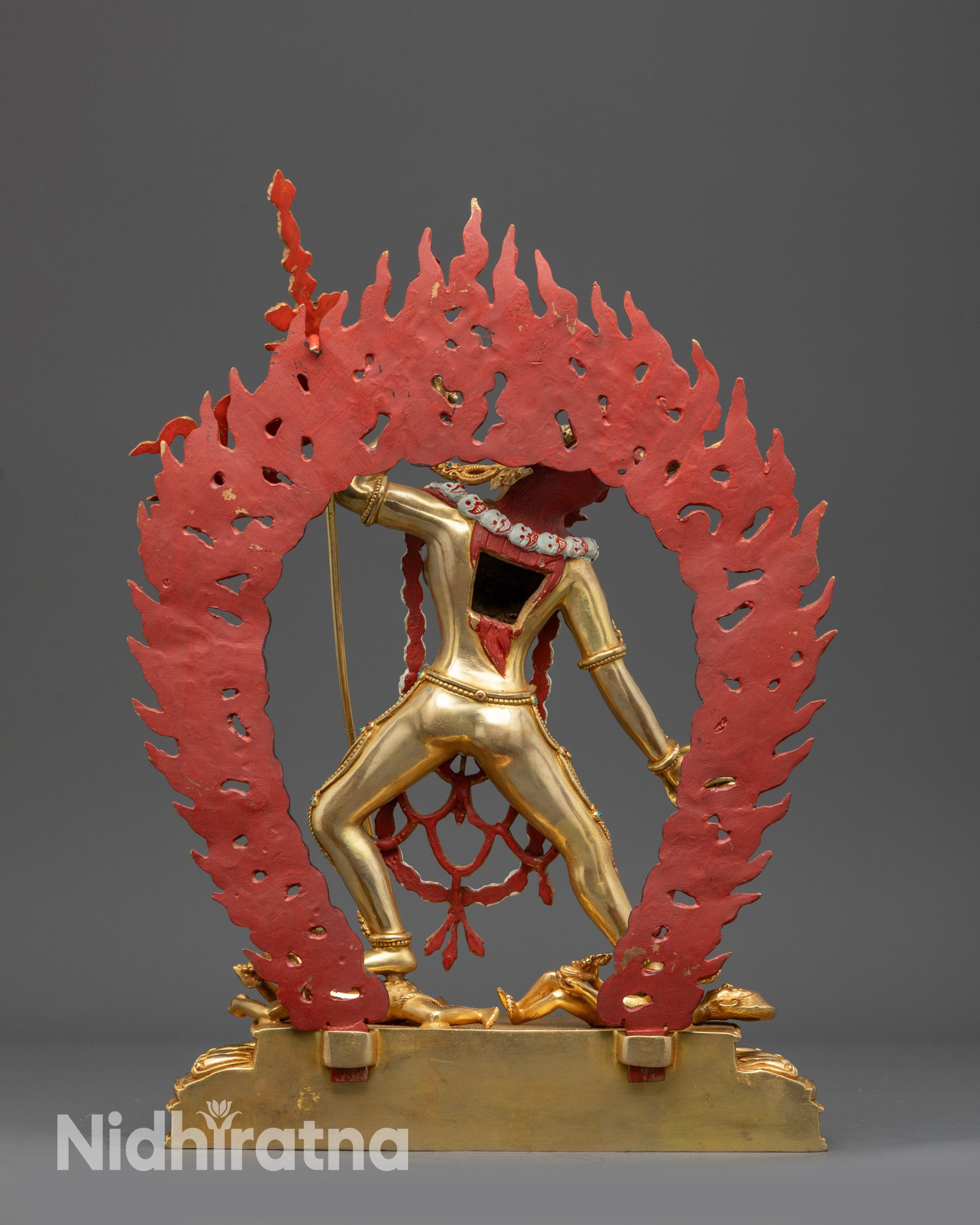 Back view Vajrayogini statue highlighting swirling robes, flames, and carved skull halo