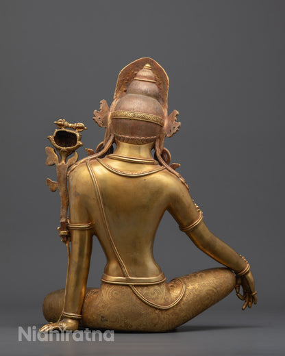 Back view highlighting the finely carved lower garment and rich detailing on statue