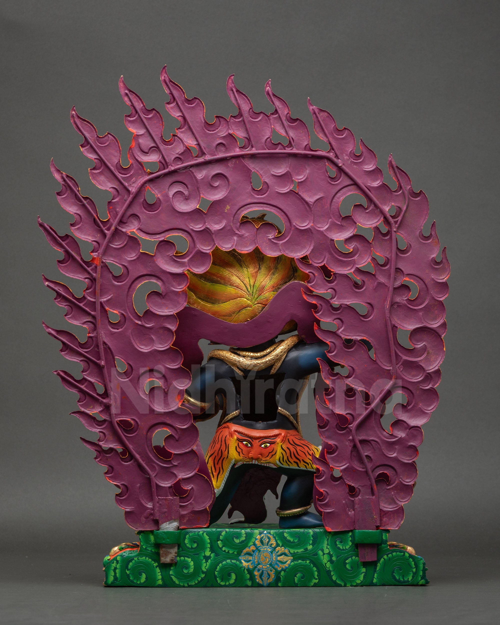 Back view of Achala Statue showing robe, halo, and intricate carvings