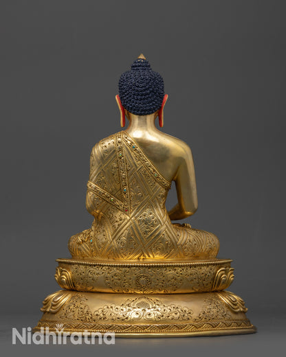 Back view of Amitabha Buddha statue showing intricate carved patterns on robe and base 