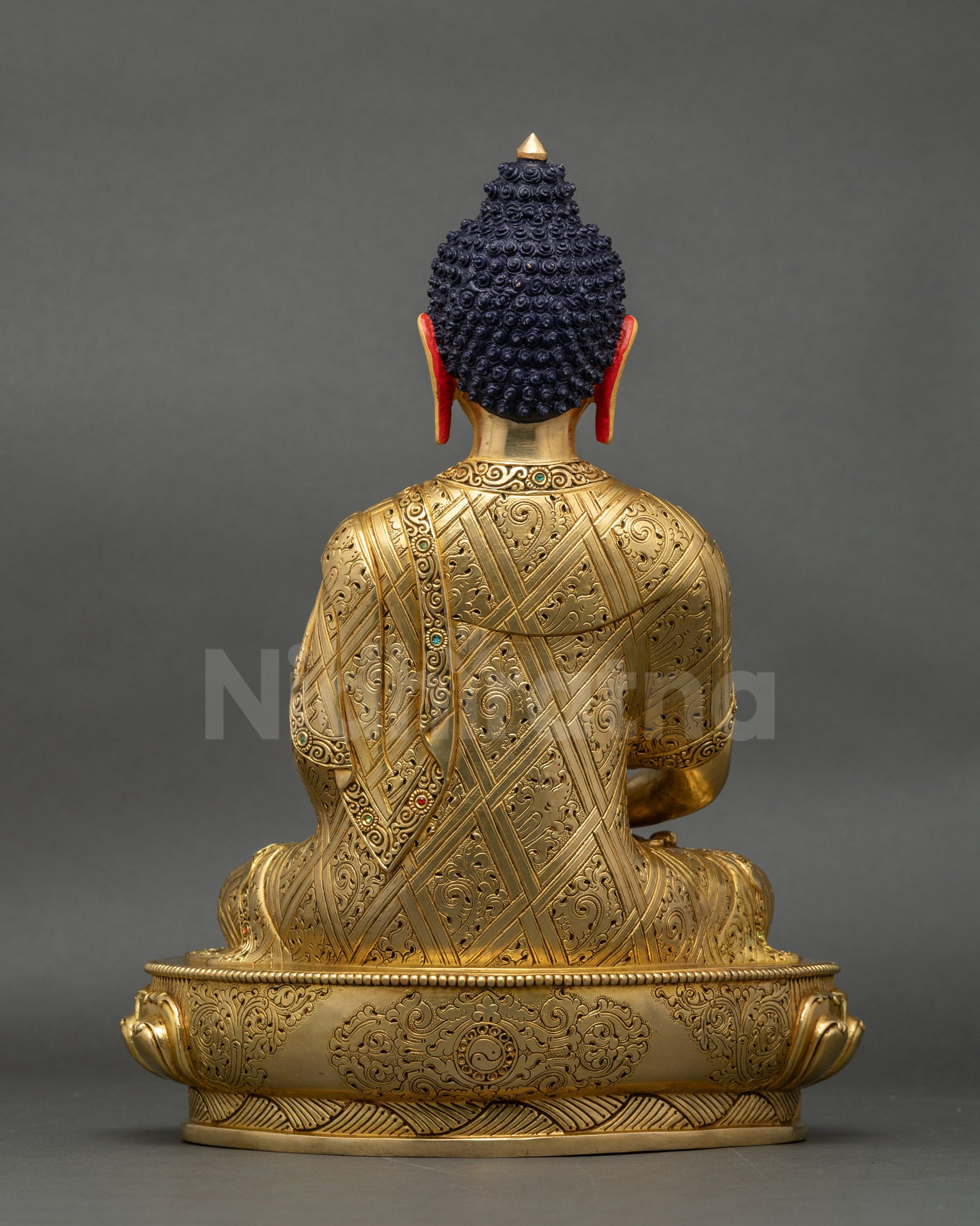 Back view of Amitabha Buddha statue with carved robe details and lotus pedestal