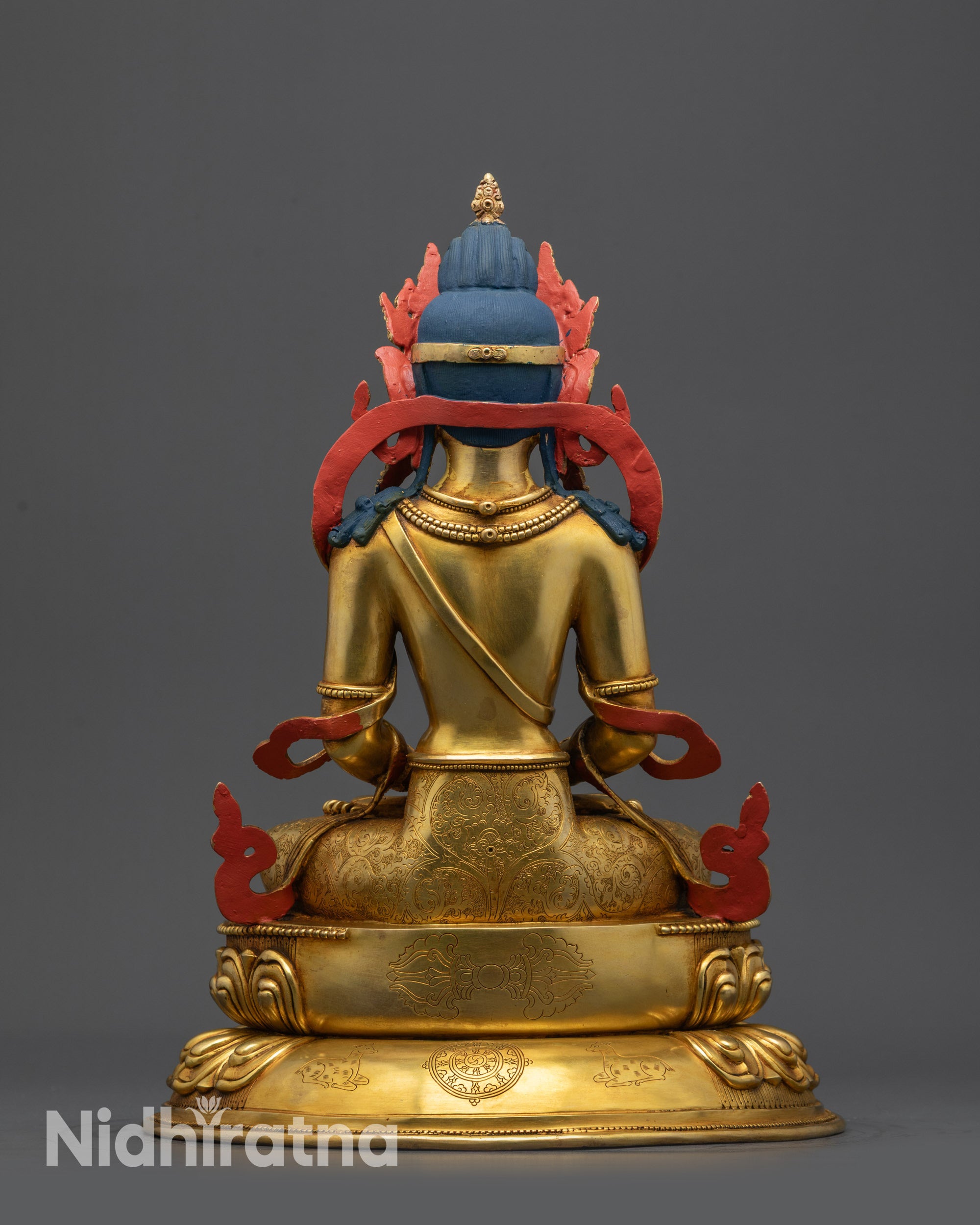 Back view of Amitayus Statue with dorje dharma wheel and deer carving on base
