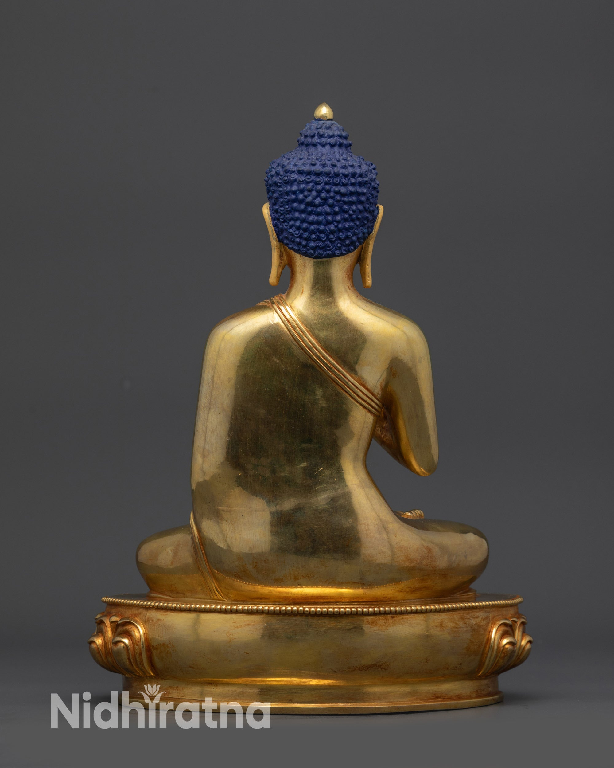 Back view of Amoghasiddhi Buddha statue displaying polished robe and craftsmanship