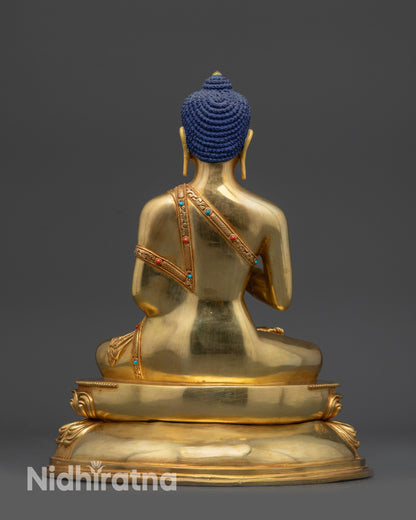 Back view of Amoghasiddhi Buddha statue showing polished robe and intricate lotus pedestal
