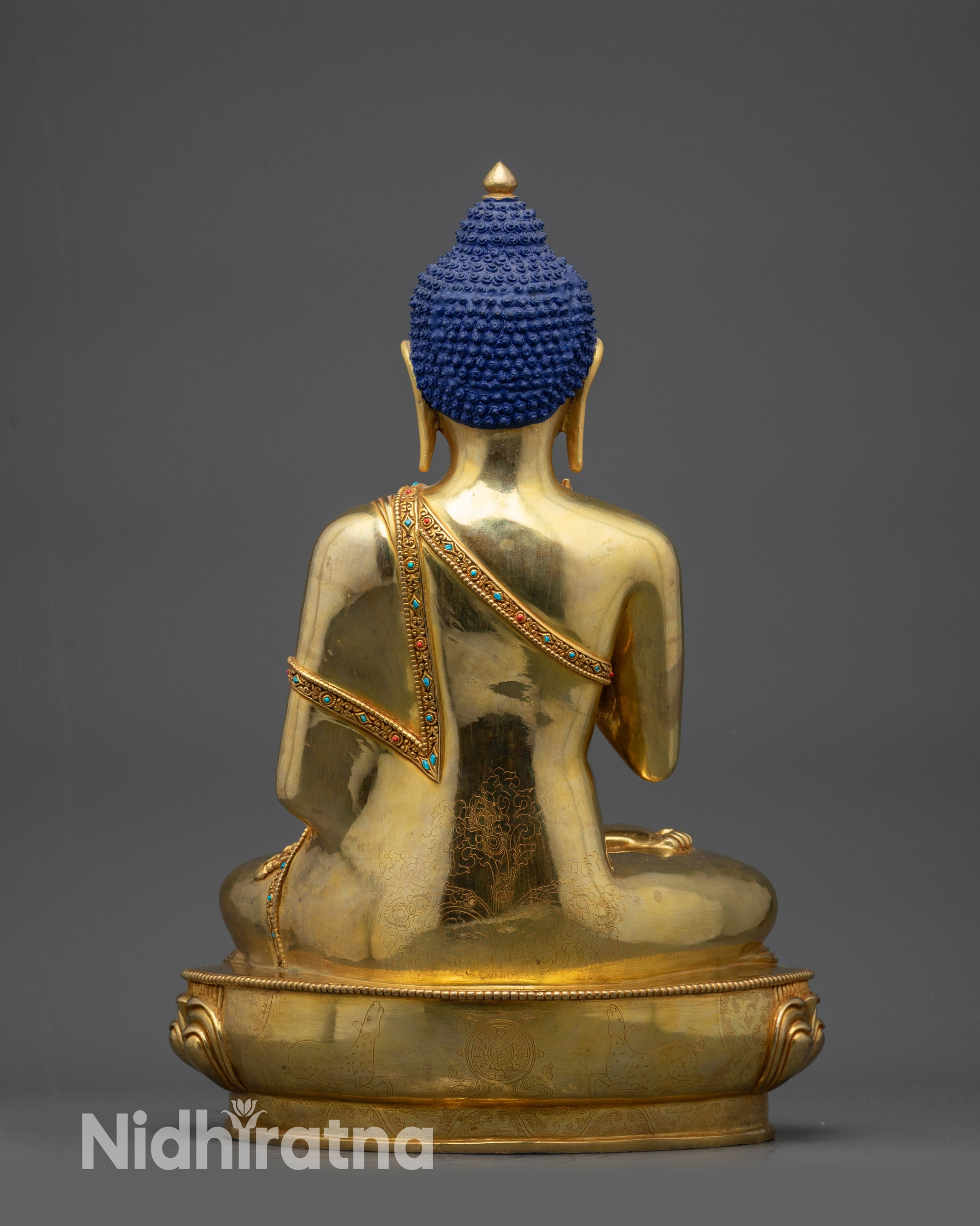 Back view of Amoghasiddhi Buddha statue with detailed robe and polished finish