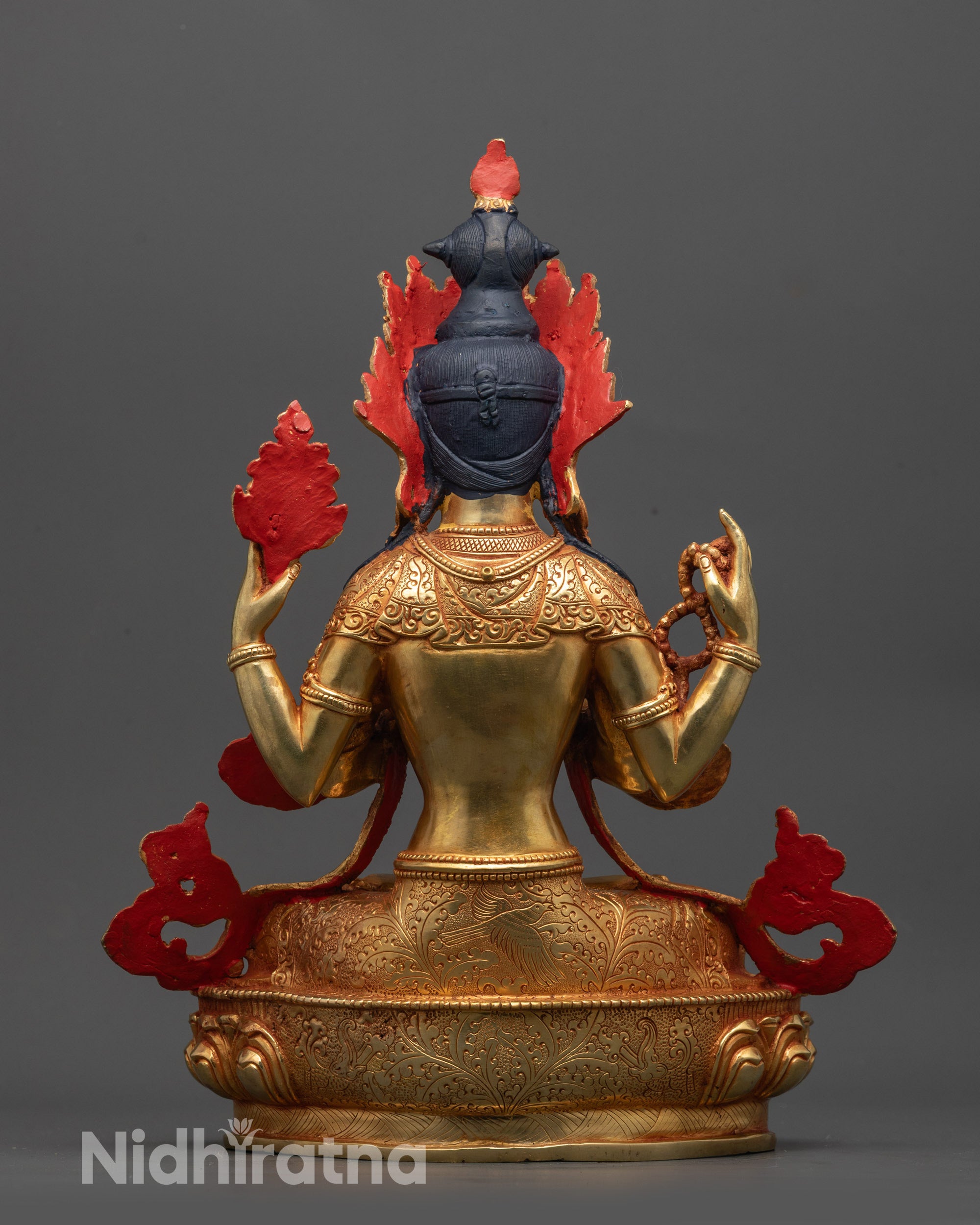 Back view of Avalokiteshvara statue displaying detailed gold-gilded patterns and serene pose