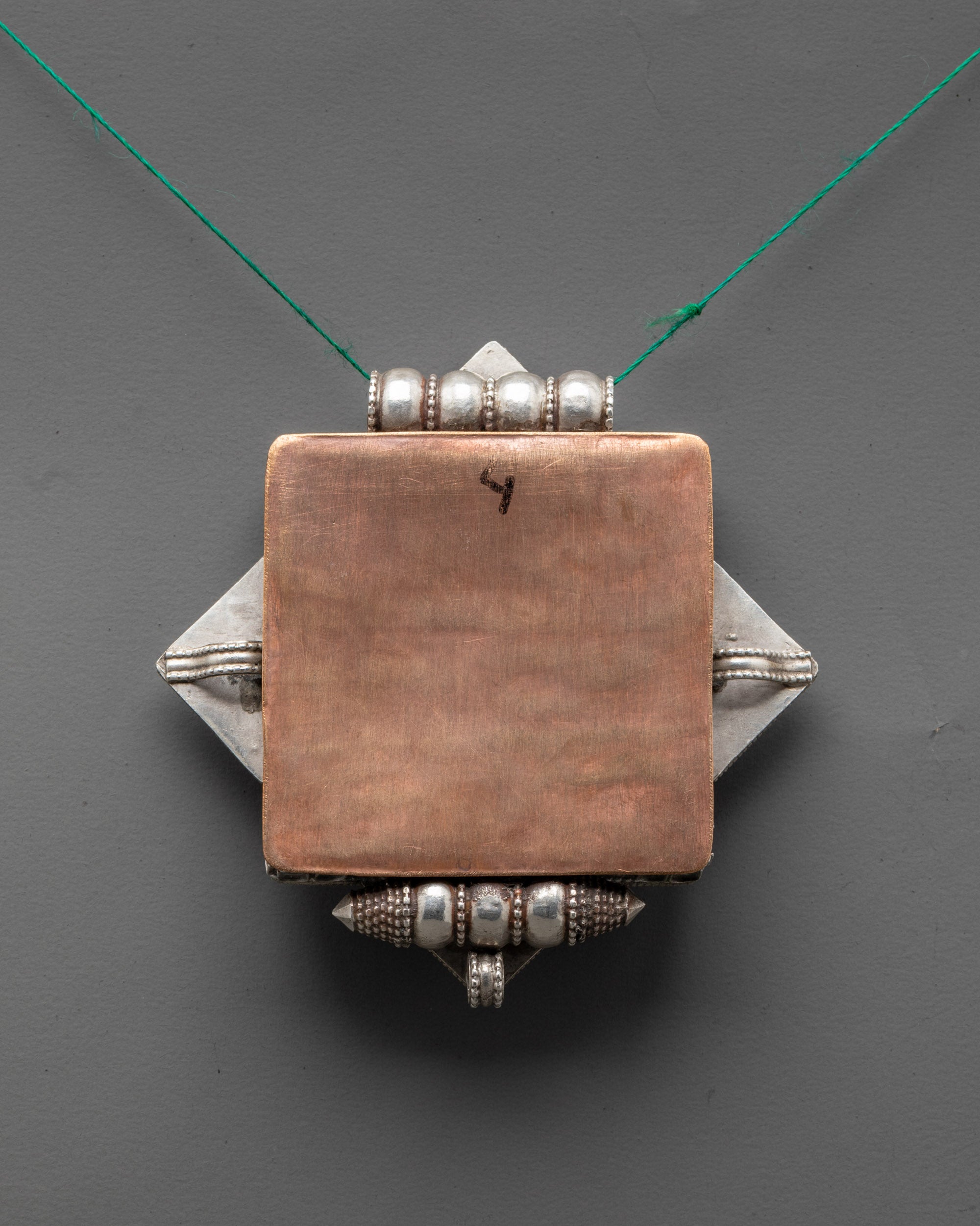 Back view of Bishwo Vajra Locket displaying expert artisan carving and traditional Tibetan design
