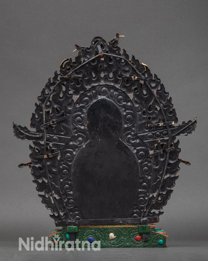 Back view of Black Dzambhala statue showing lotus throne and flame halo engraving