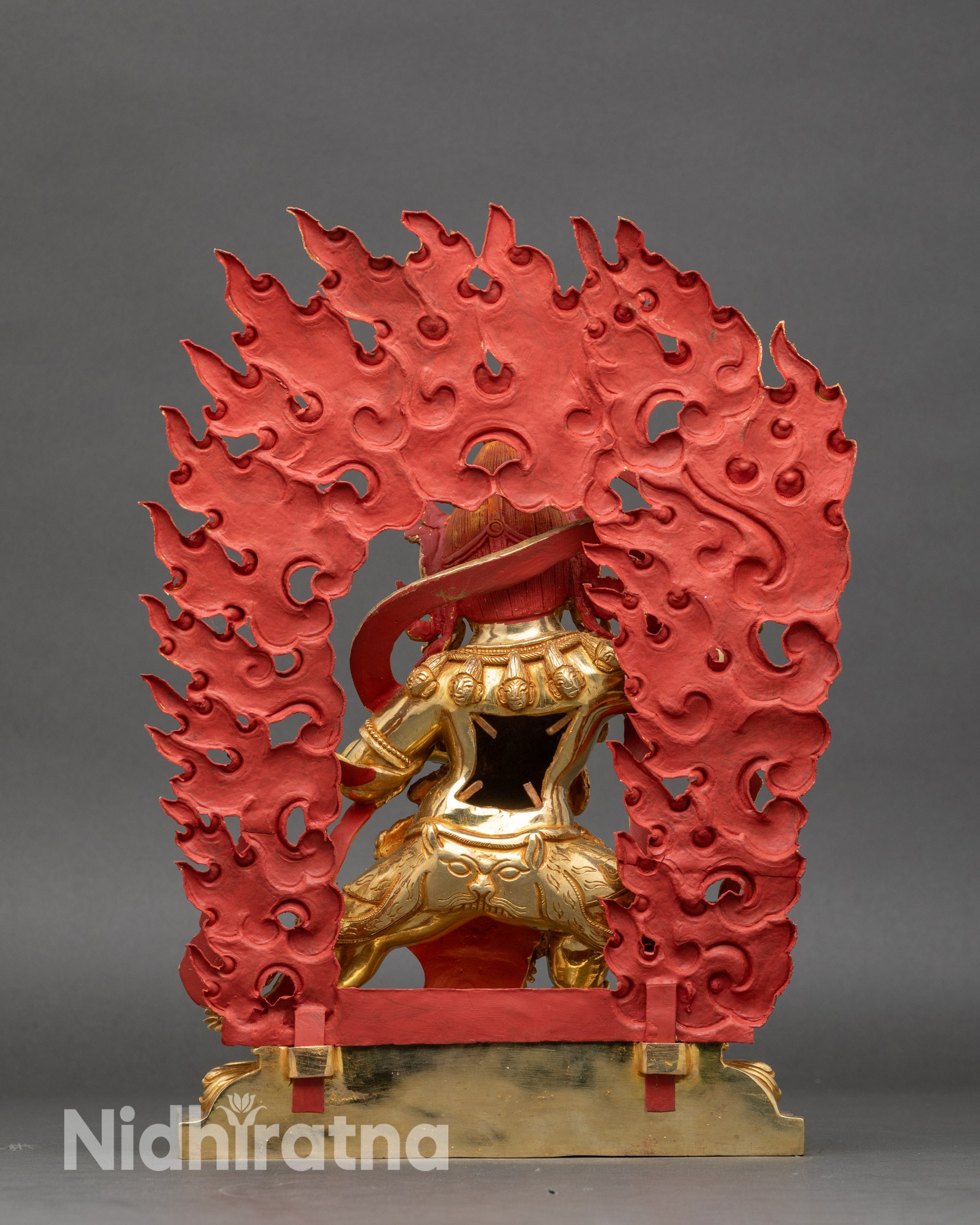 Back view of Black Manjushri statue showing engraved details and golden highlights
