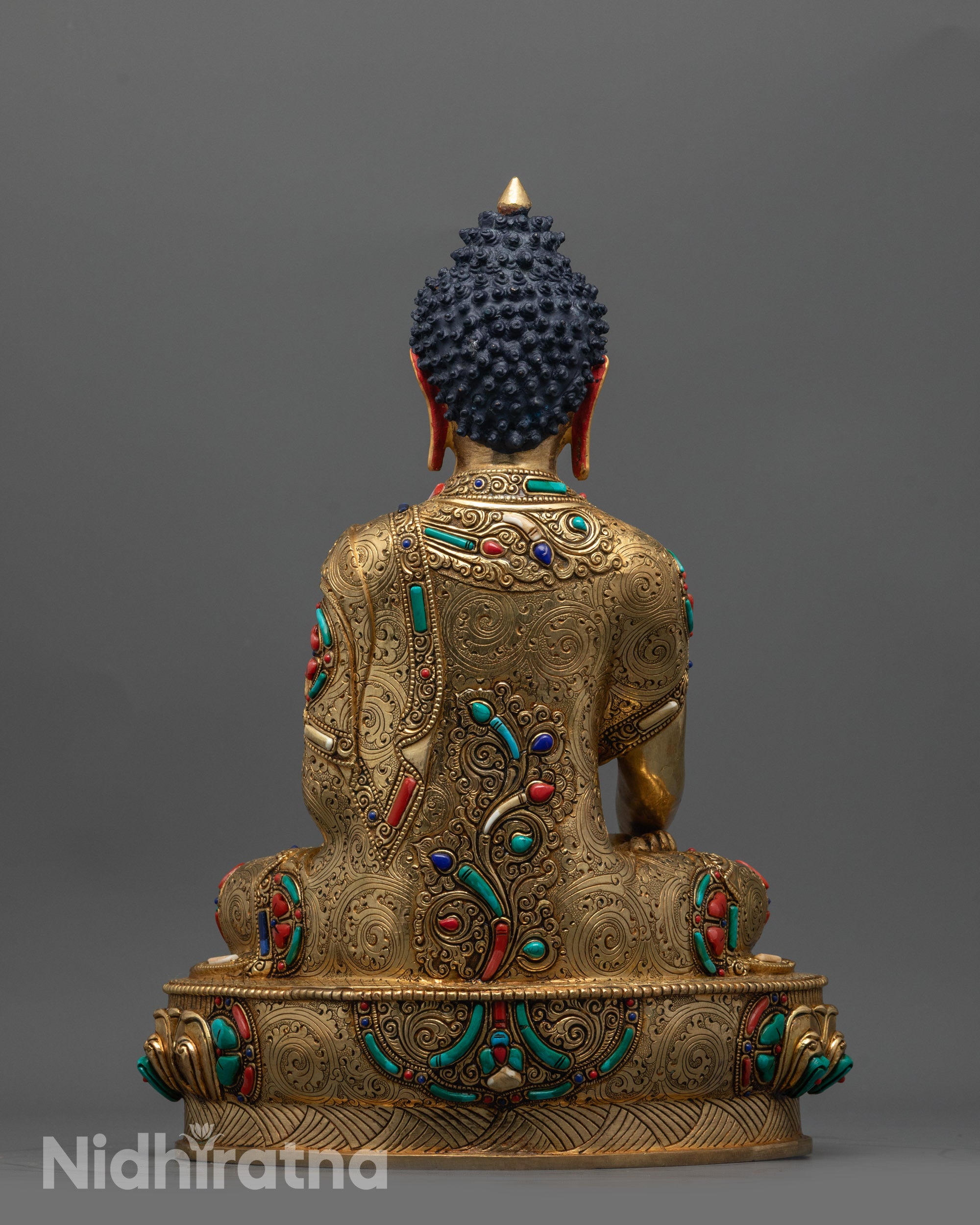 Back view of Buddha Shakyamuni Statue displaying detailed robe patterns and serene posture