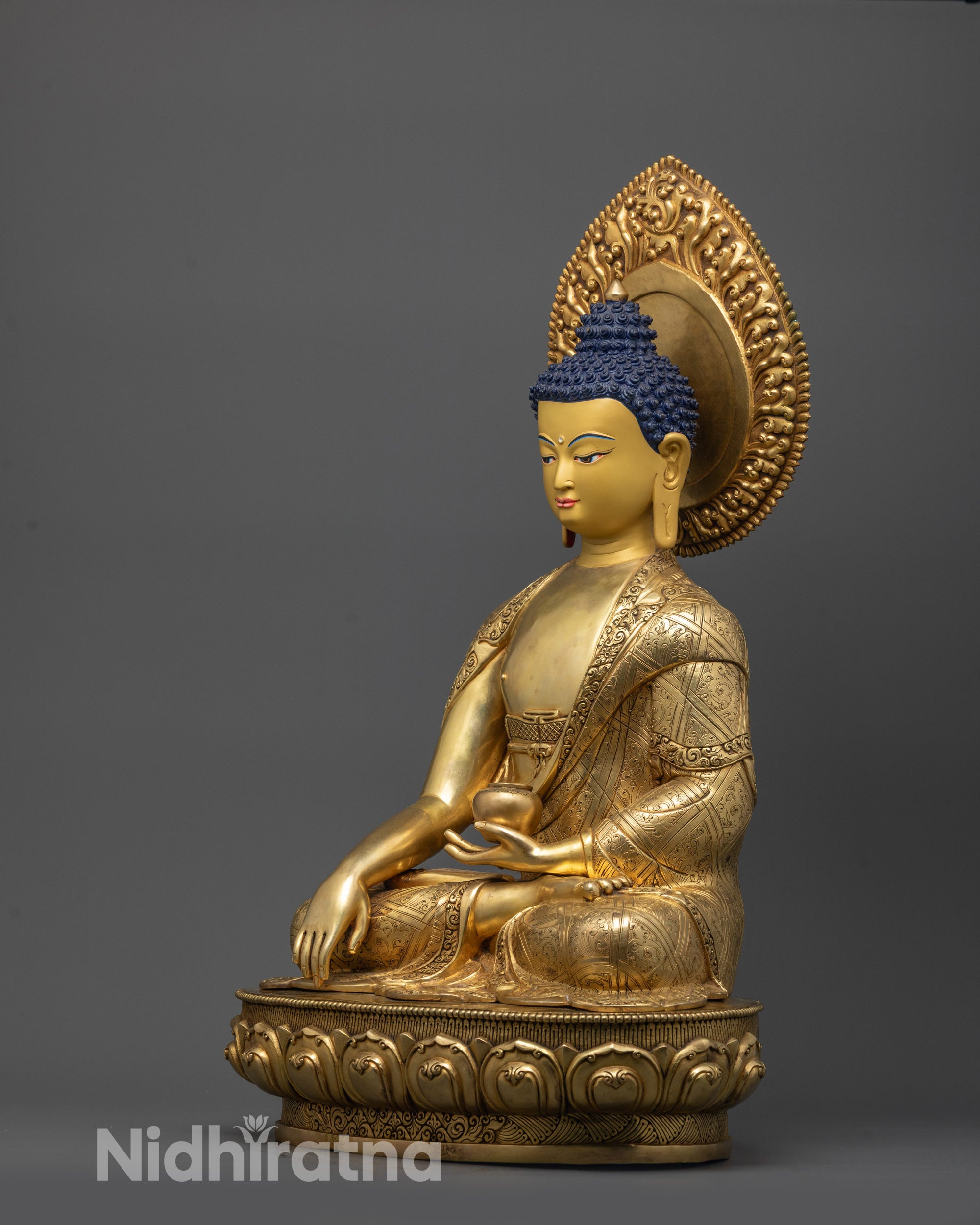Back view of Buddha Shakyamuni statue highlighting carved garment patterns and halo