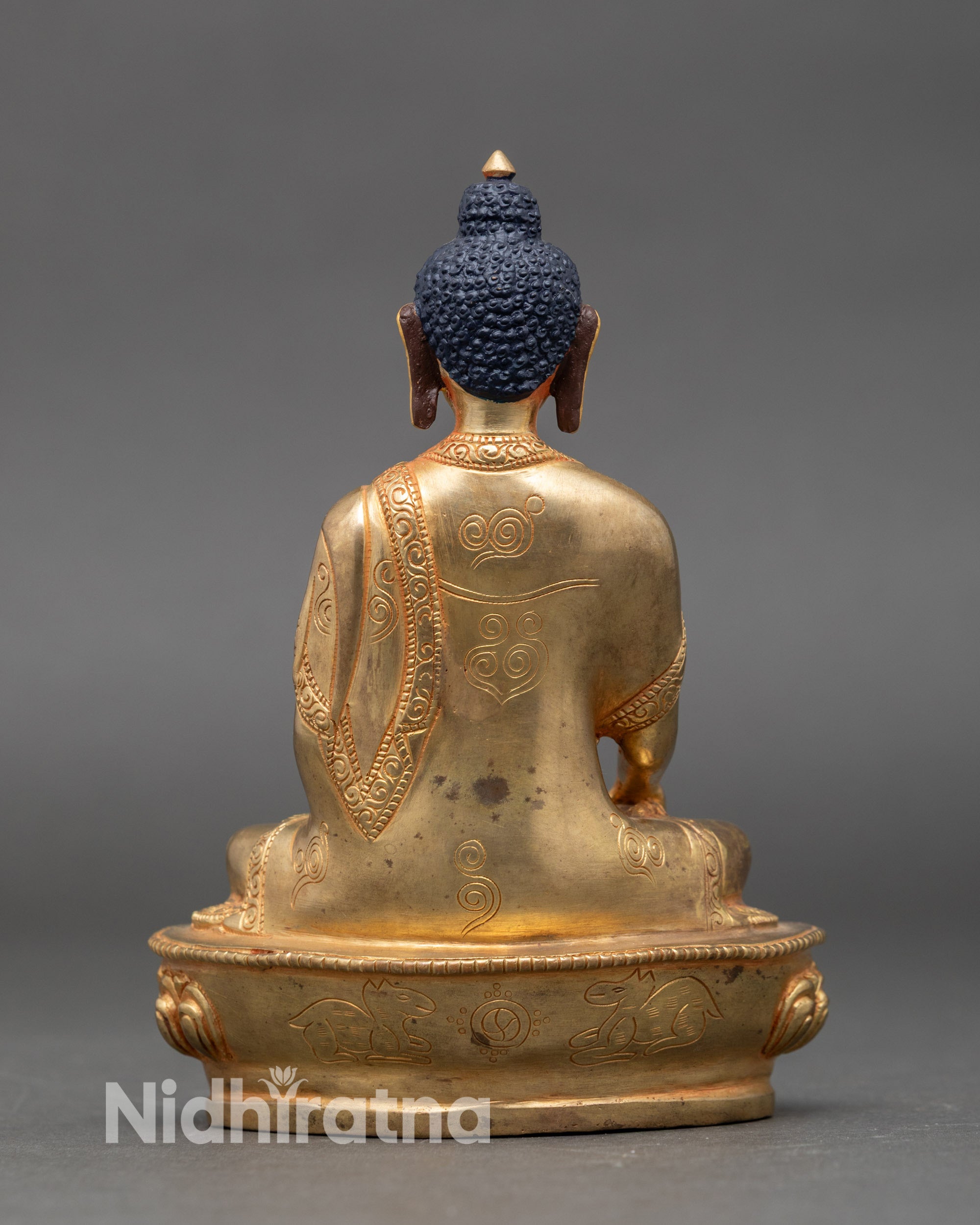 Back view of Buddha Shakyamuni statue highlighting intricate copper and gilded craftsmanship