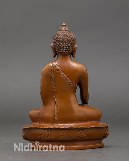 Back view of Buddha Shakyamuni statue highlighting intricate robes and lotus throne details