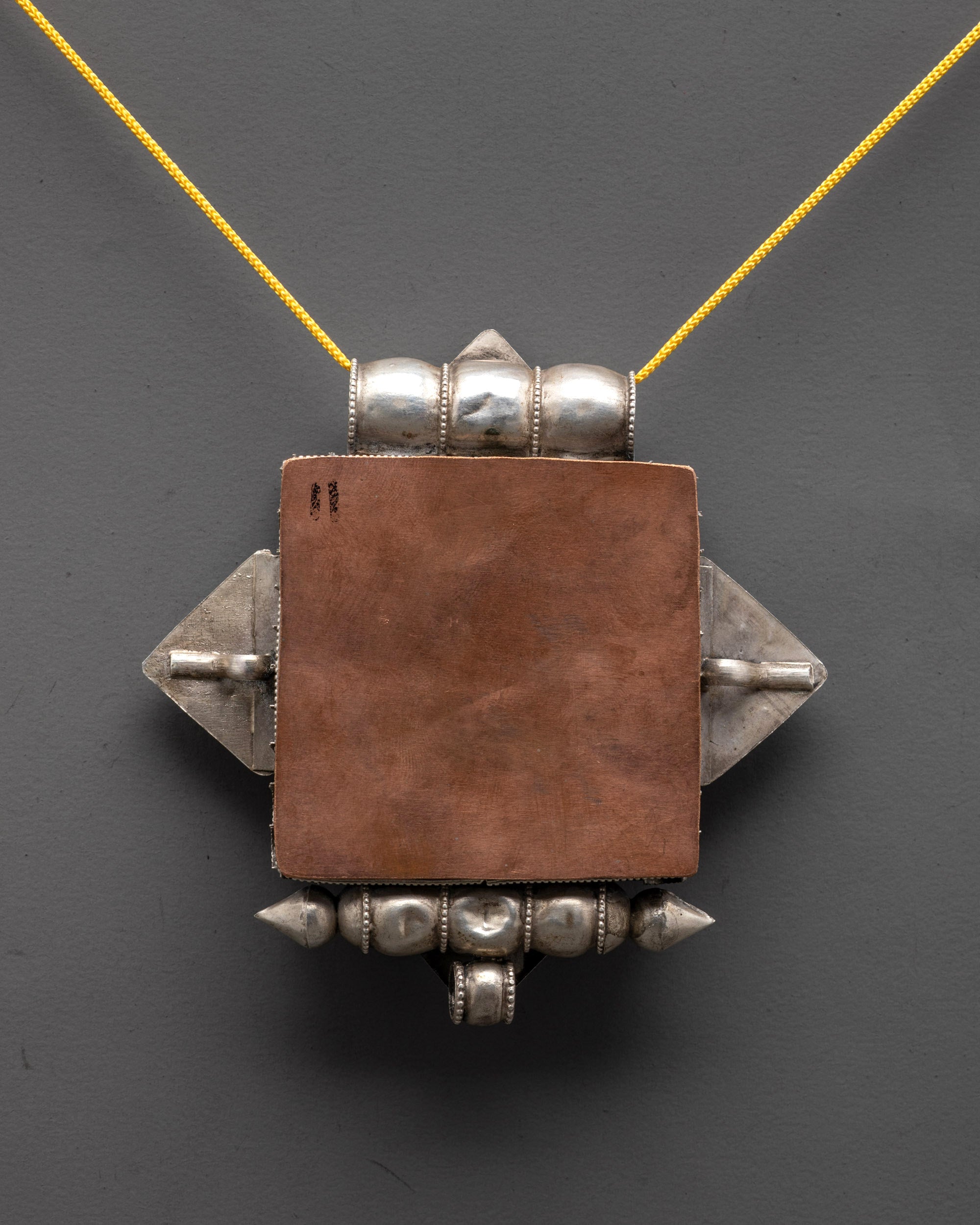 Back view of Buddhist Treasure Vase Locket highlighting craftsmanship and filigree pattern