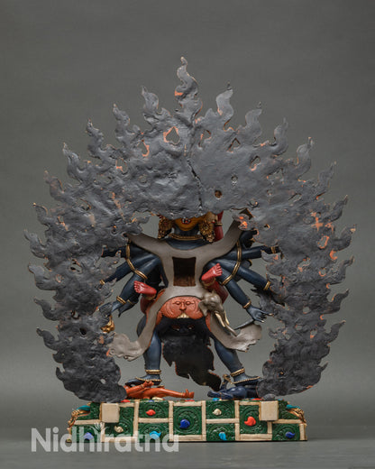 Back view of Chakrasamvara and Vajravarahi sculpture showing lotus seat and halo framing