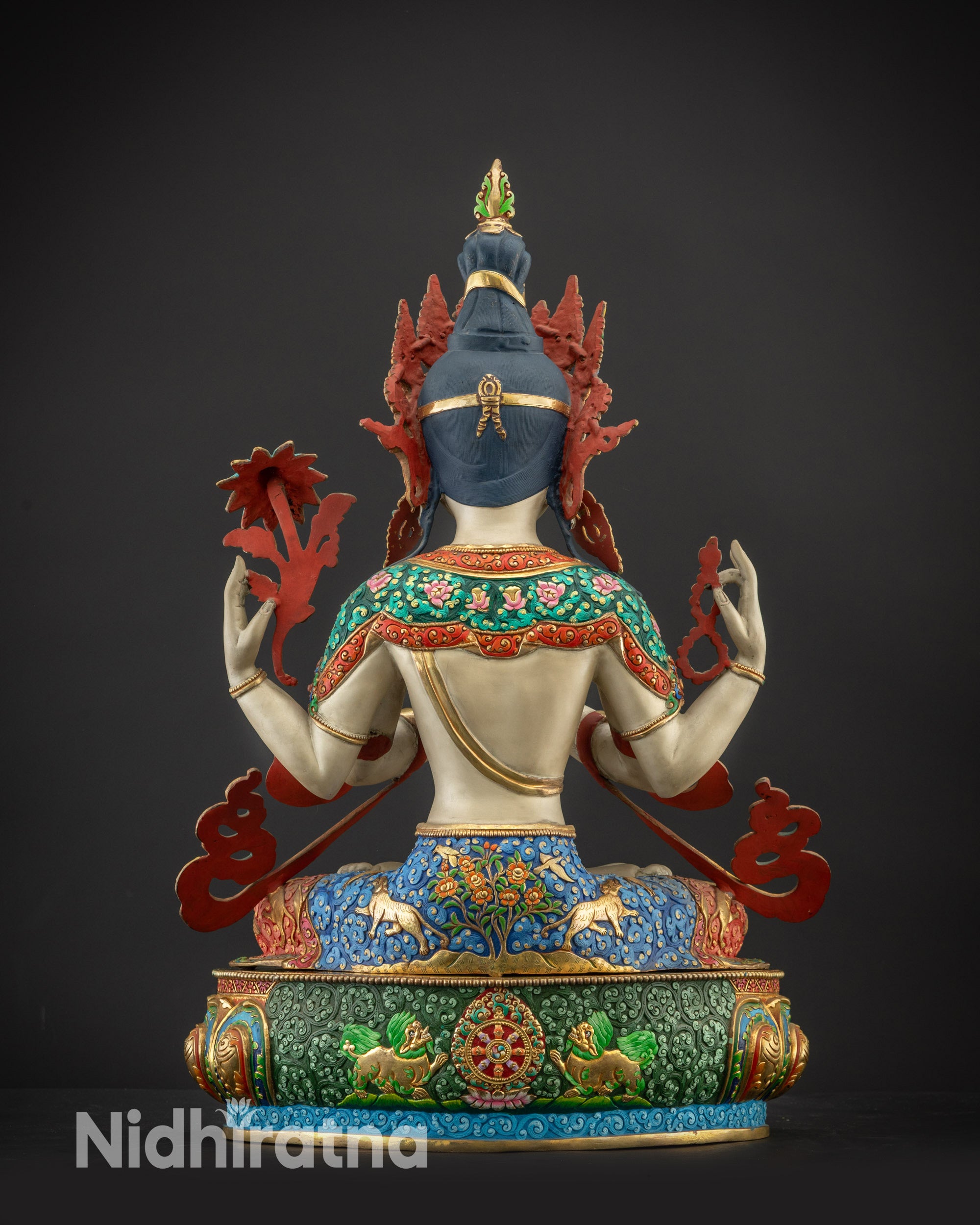 Back view of Chenrezig Statue showing carved dharma wheel, lions, and gold-accented details