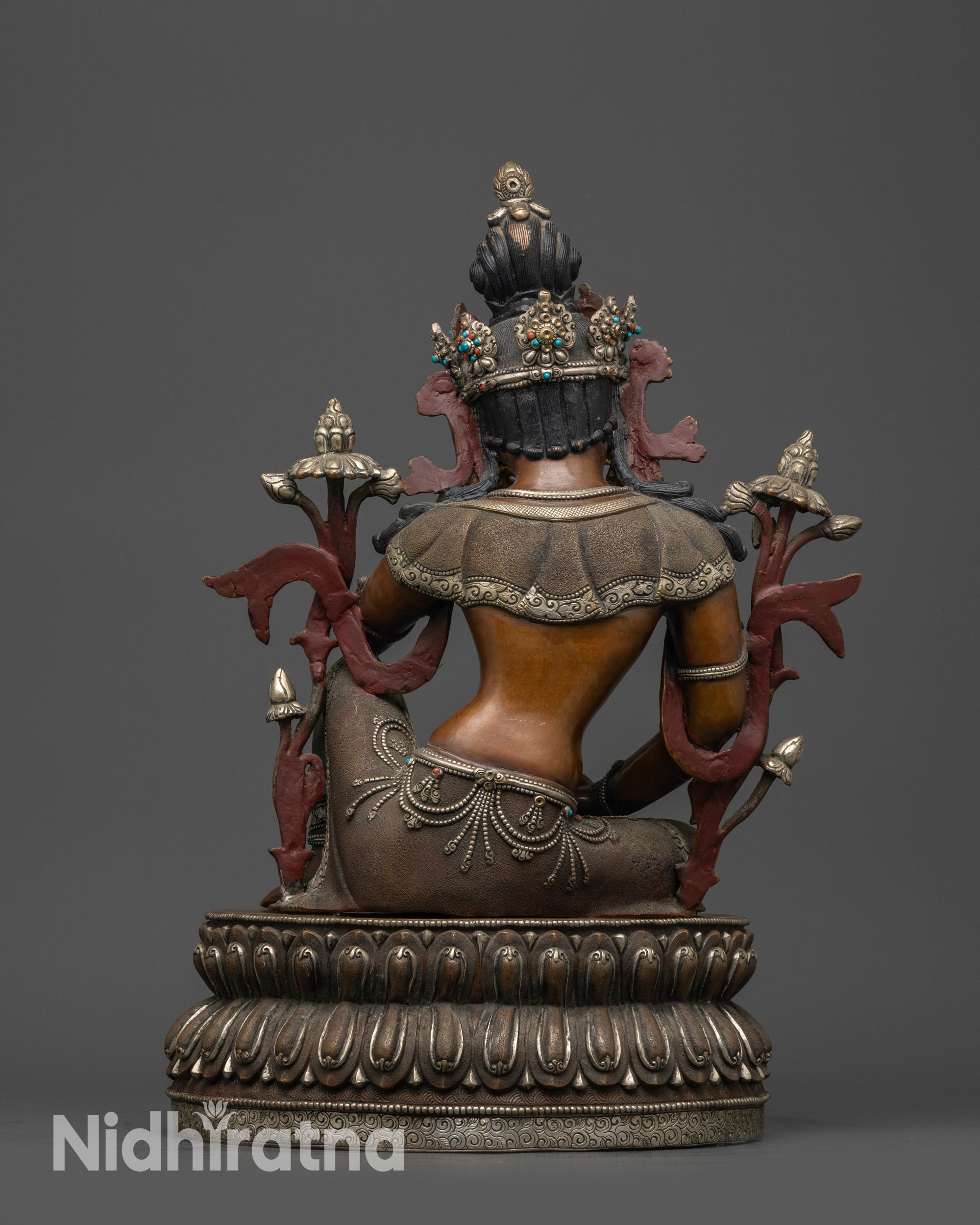 Back view of Chenrezig statue seated on double-layered lotus with detailed lower garments