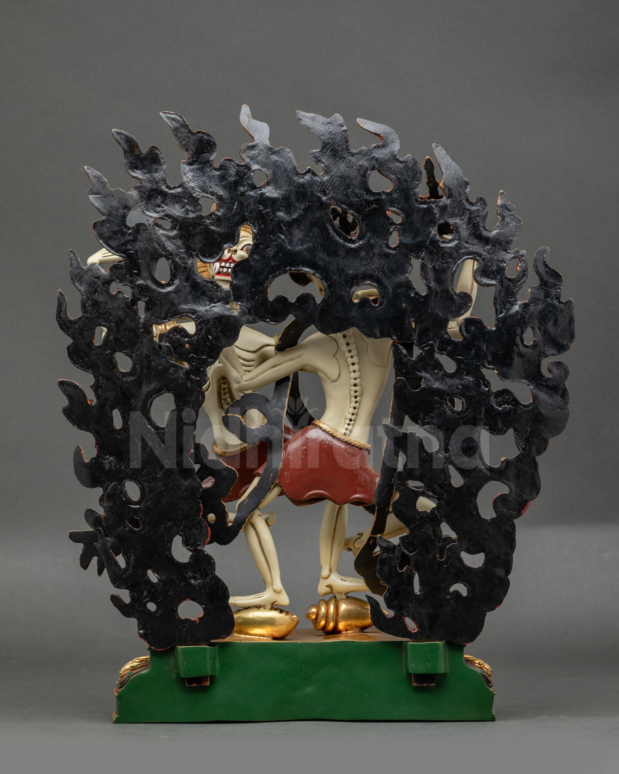 Back view of Citipati Sculpture highlighting detailed robes and blazing halo