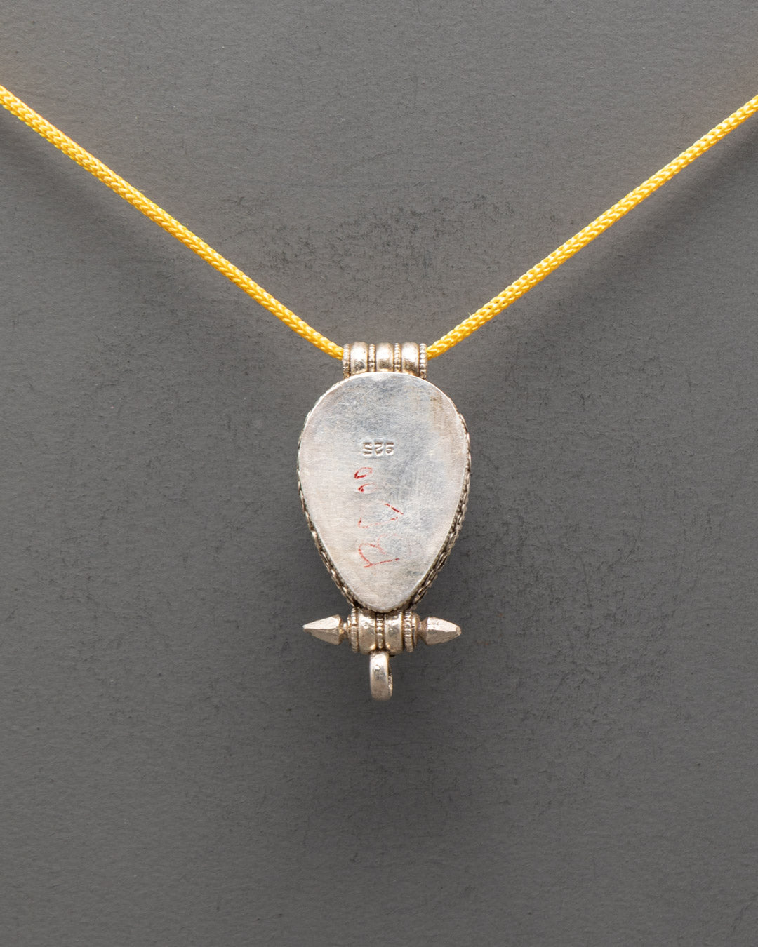 Back view of Classic Tibetan Lapis Lazuli locket with carved silver patterns