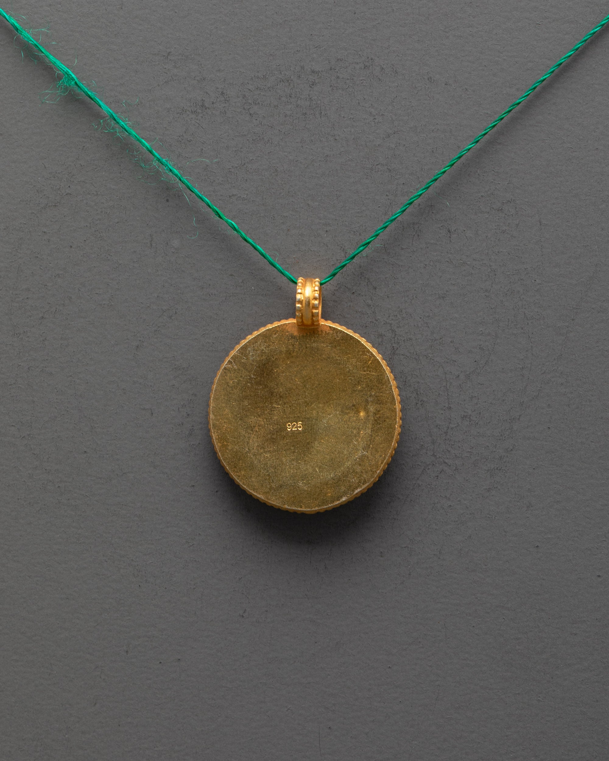 Back view of Dharma Wheel Locket showing smooth copper finish and artisan craftsmanship