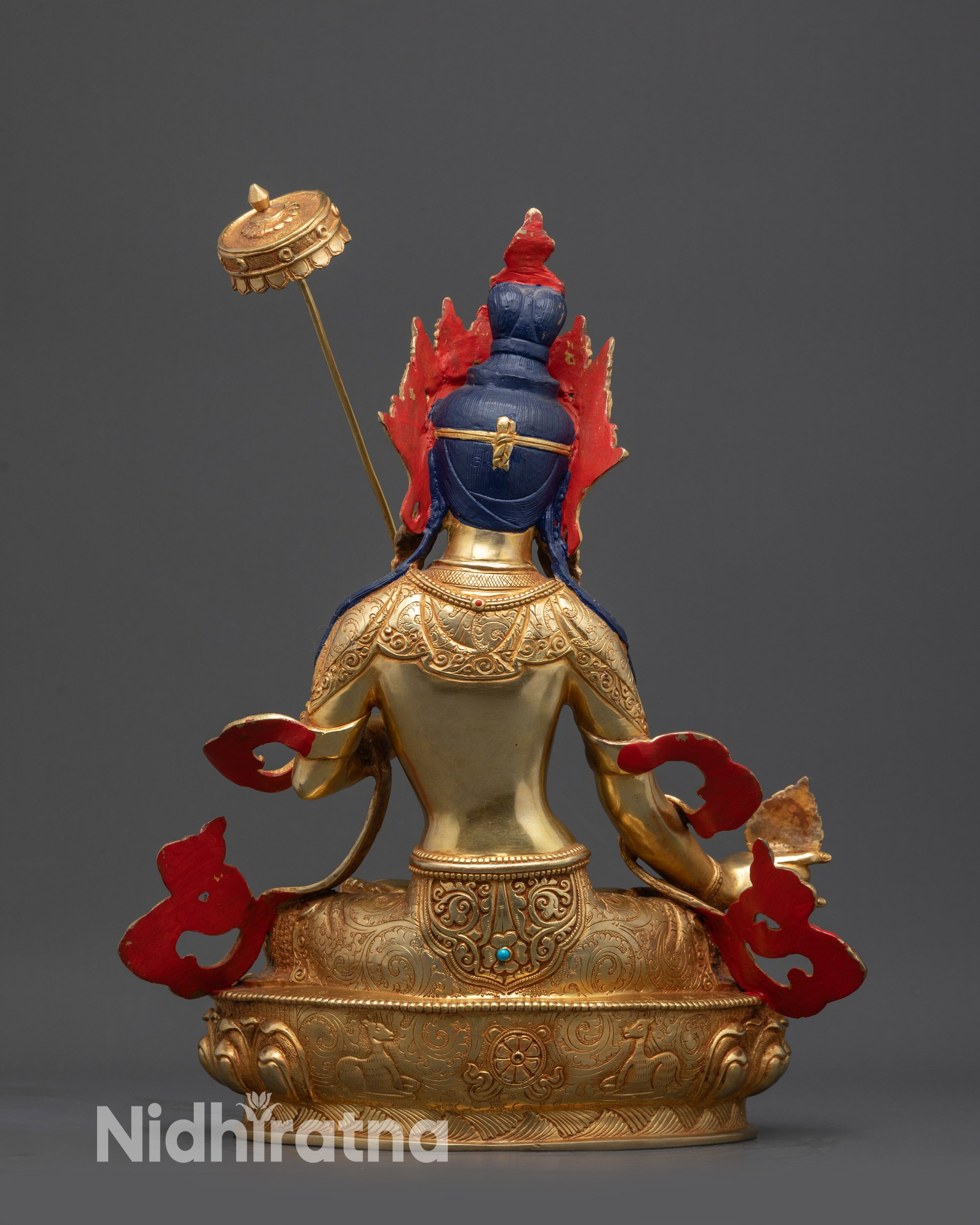 Back view of Dukar statue showing lotus pedestal, sun disc, and detailed robe carvings