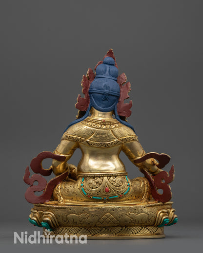  Back view of Dzambhala statue displaying serpent, detailed garment carvings, and polished finish 
