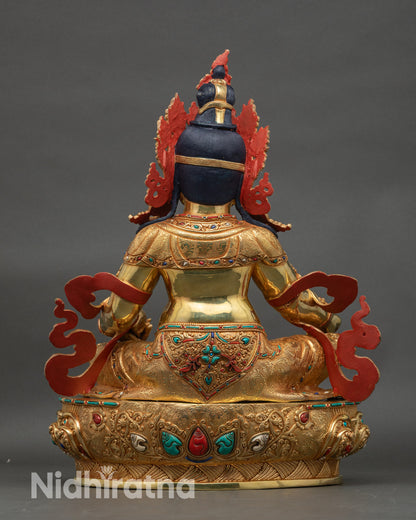 Back view of Dzambhala statue showing sculpted robe details and traditional Nepal artistry